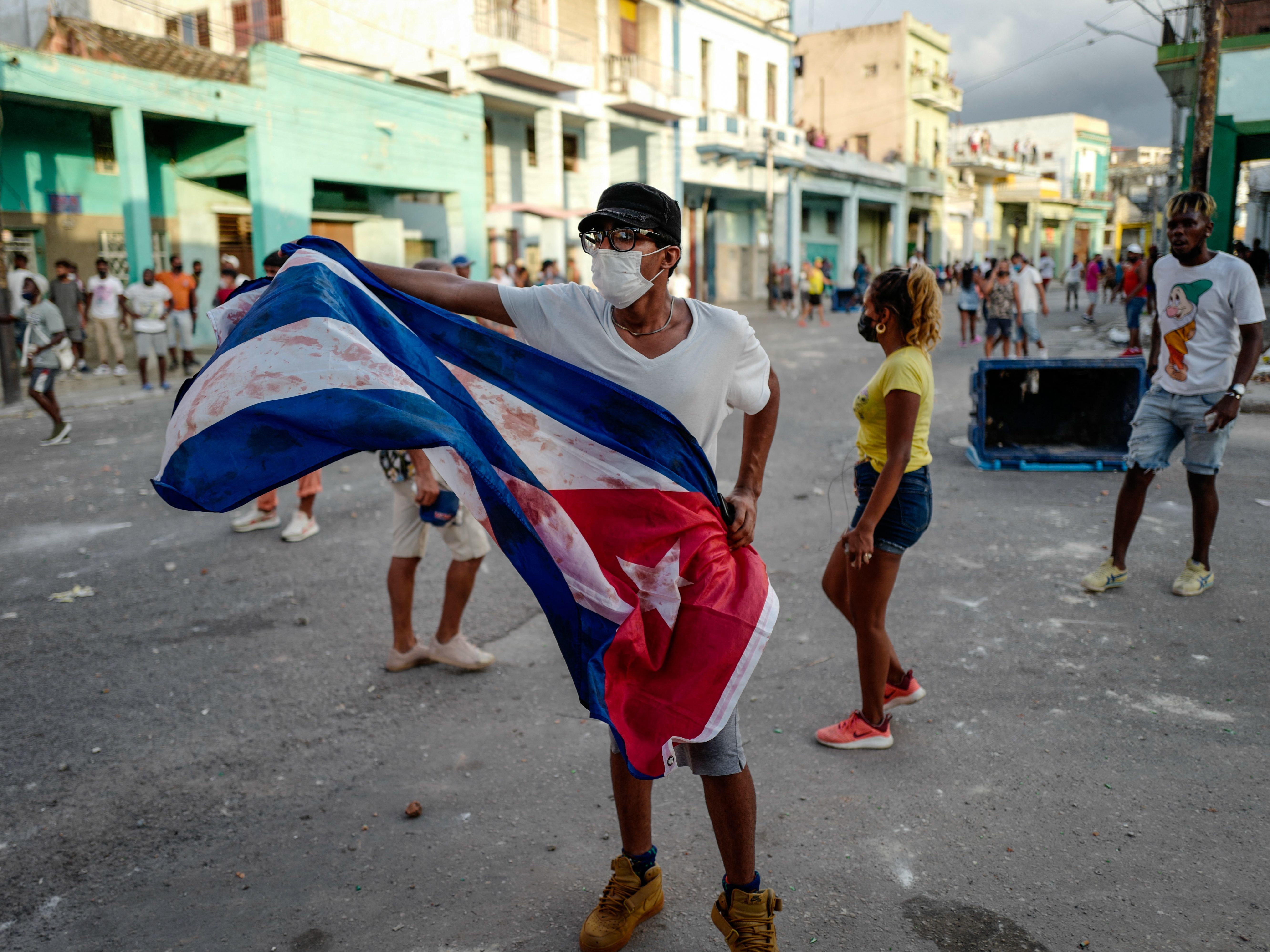A man waves a Cuban flag during a demonstration against Cuban President Miguel Díaz-Canel's government Sunday in Havana as large numbers take part in rare protests against the communist regime. (AFP via Getty Images)