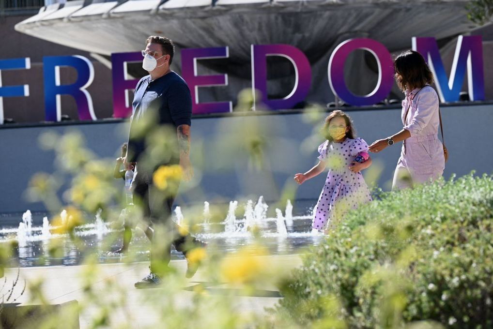People enjoy an outdoor art exhibition in downtown Los Angeles in early July. Los Angeles County public health authorities are now urging unvaccinated and vaccinated people alike to wear face coverings in public indoor spaces because of the growing threat posed by the more contagious delta variant of the coronavirus. (AFP via Getty Images)