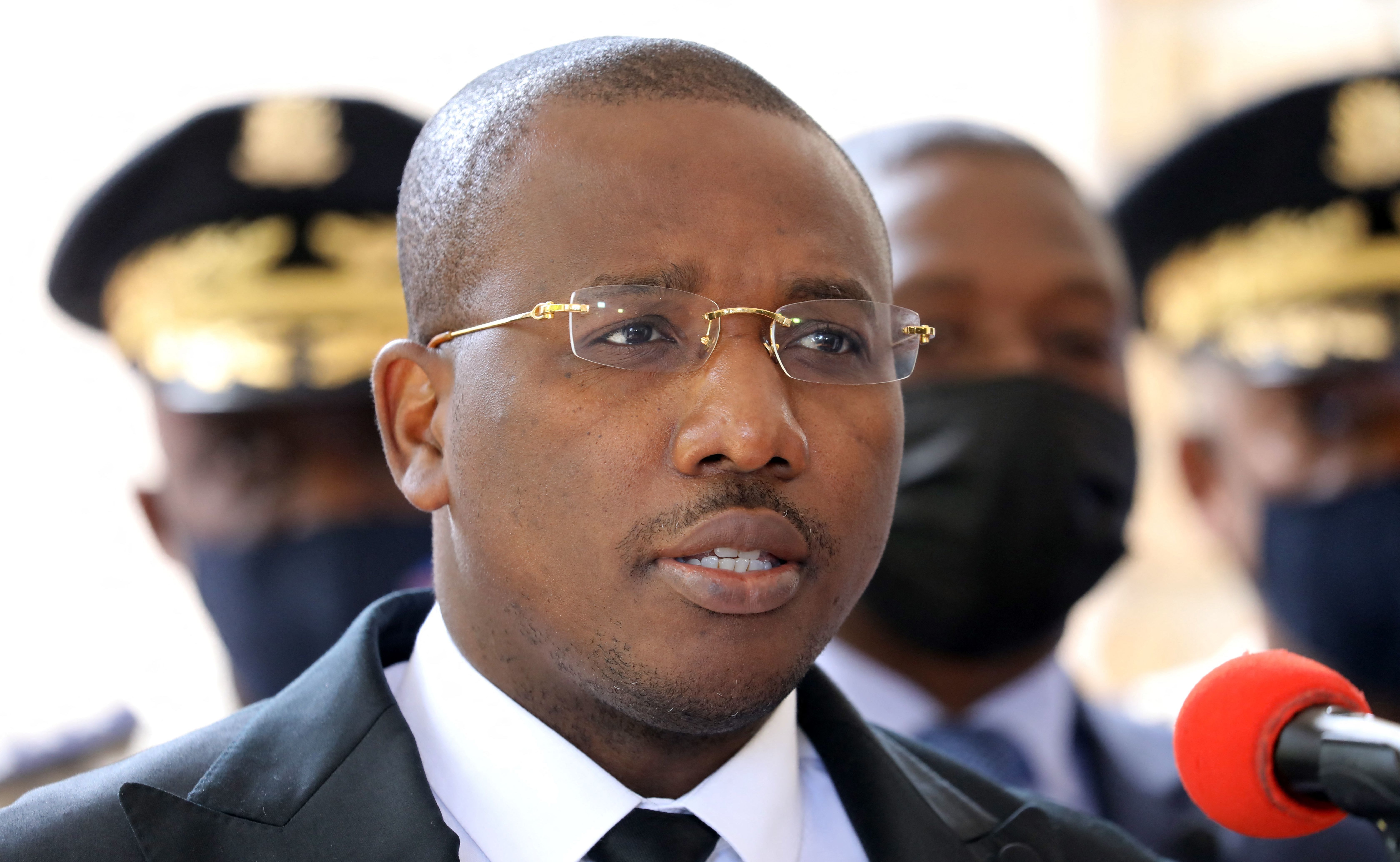 Claude Joseph speaks during a press conference Friday in Port-au-Prince. The country's interim prime minister says he's optimistic about forming a unity government. (AFP via Getty Images)