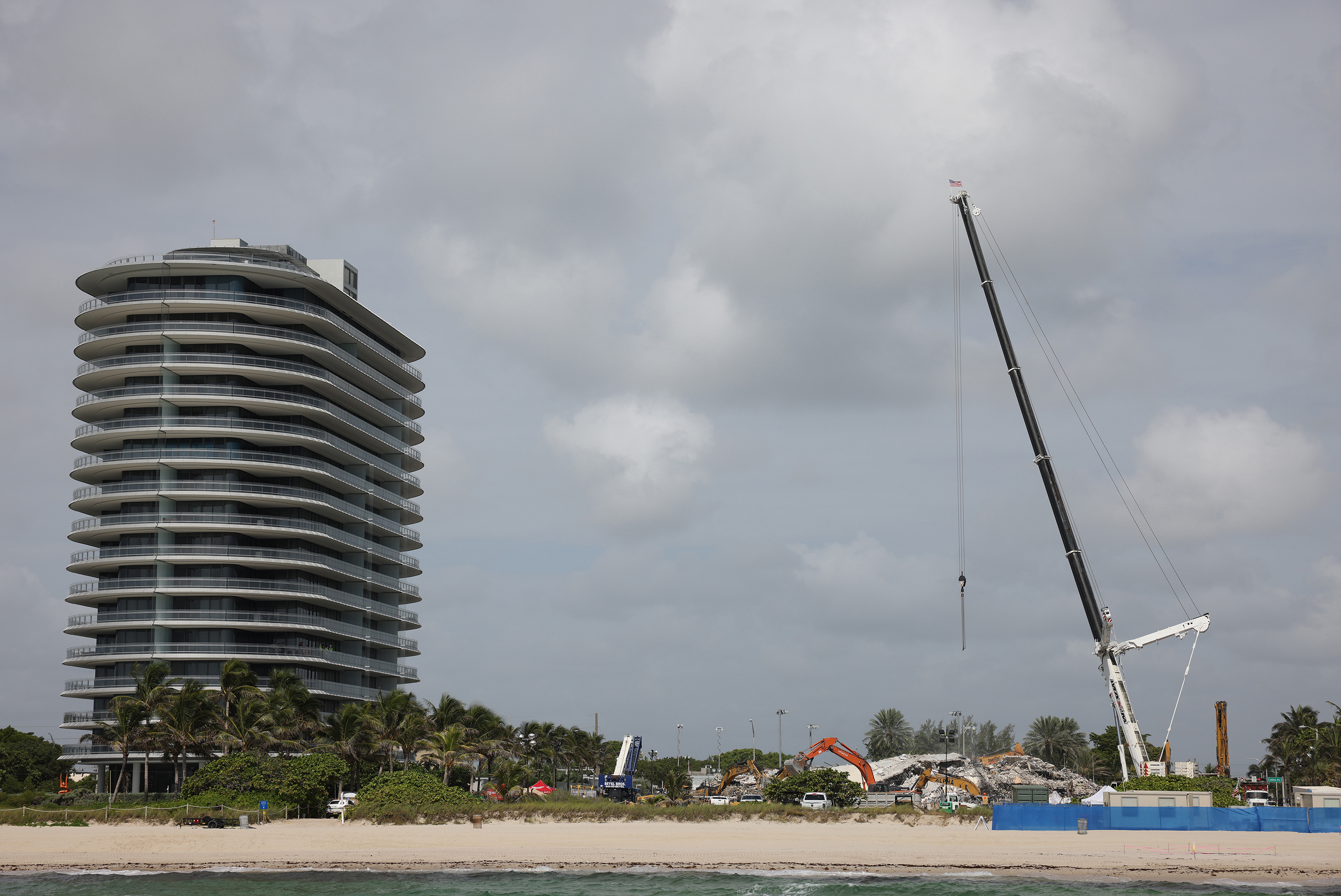 Cranes are operated over the remains from the collapsed 12-story Champlain Towers South condo building on July 9 in Surfside, Fla. (Getty Images)