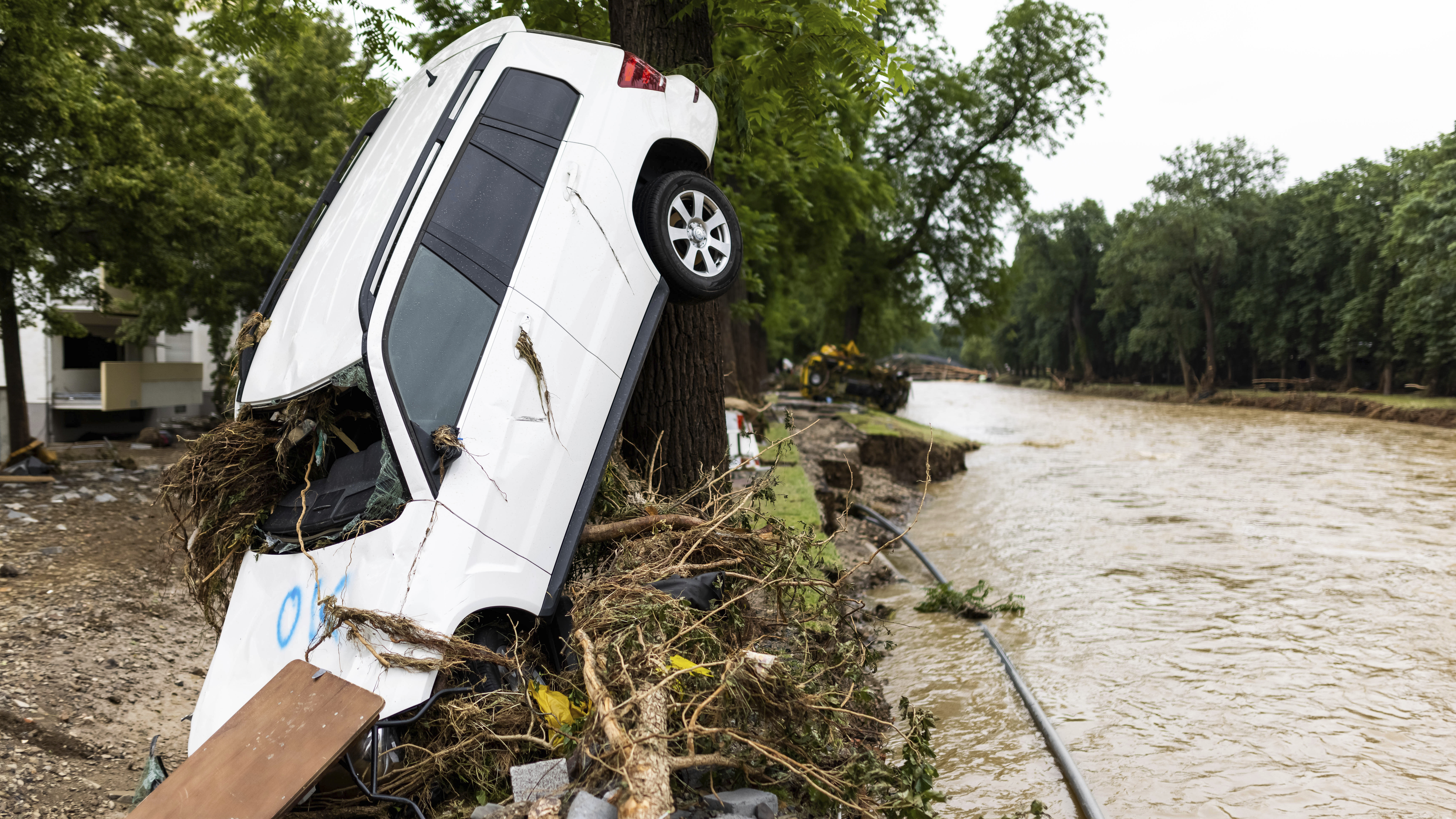 A car washed up by the flood leans against a tree near the river Ahr in Bad Neuenahr-Ahrweiler, Germany, on Friday.