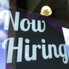 A "Now Hiring" sign is displayed on a business window on March 4, 2021, in Salem, N.H.