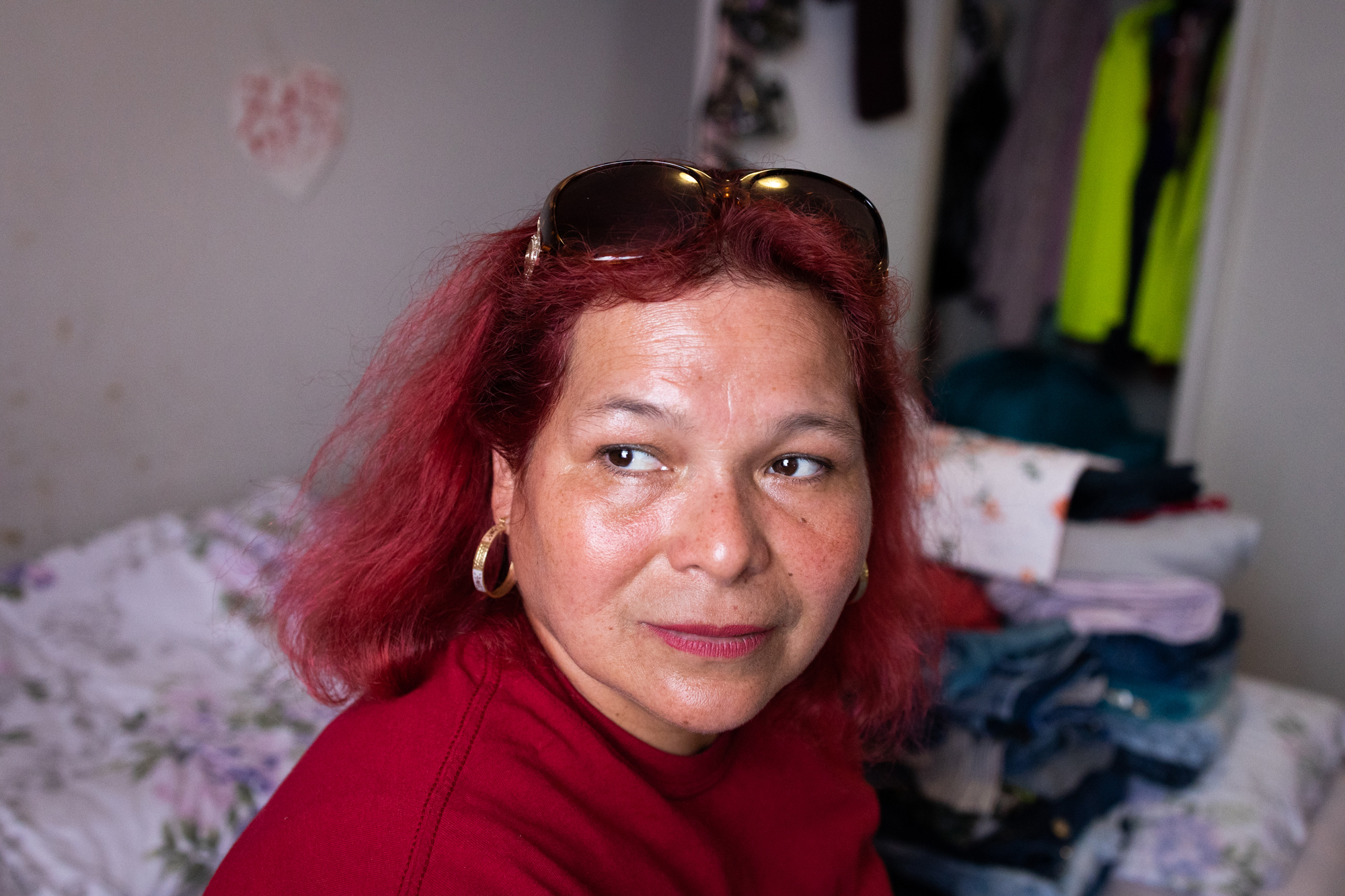 María Lara sits in her bedroom in the Bedford and Victoria Station apartment complex in Langley Park, Md., a densely populated, low-income suburb of Washington, D.C. (NPR)