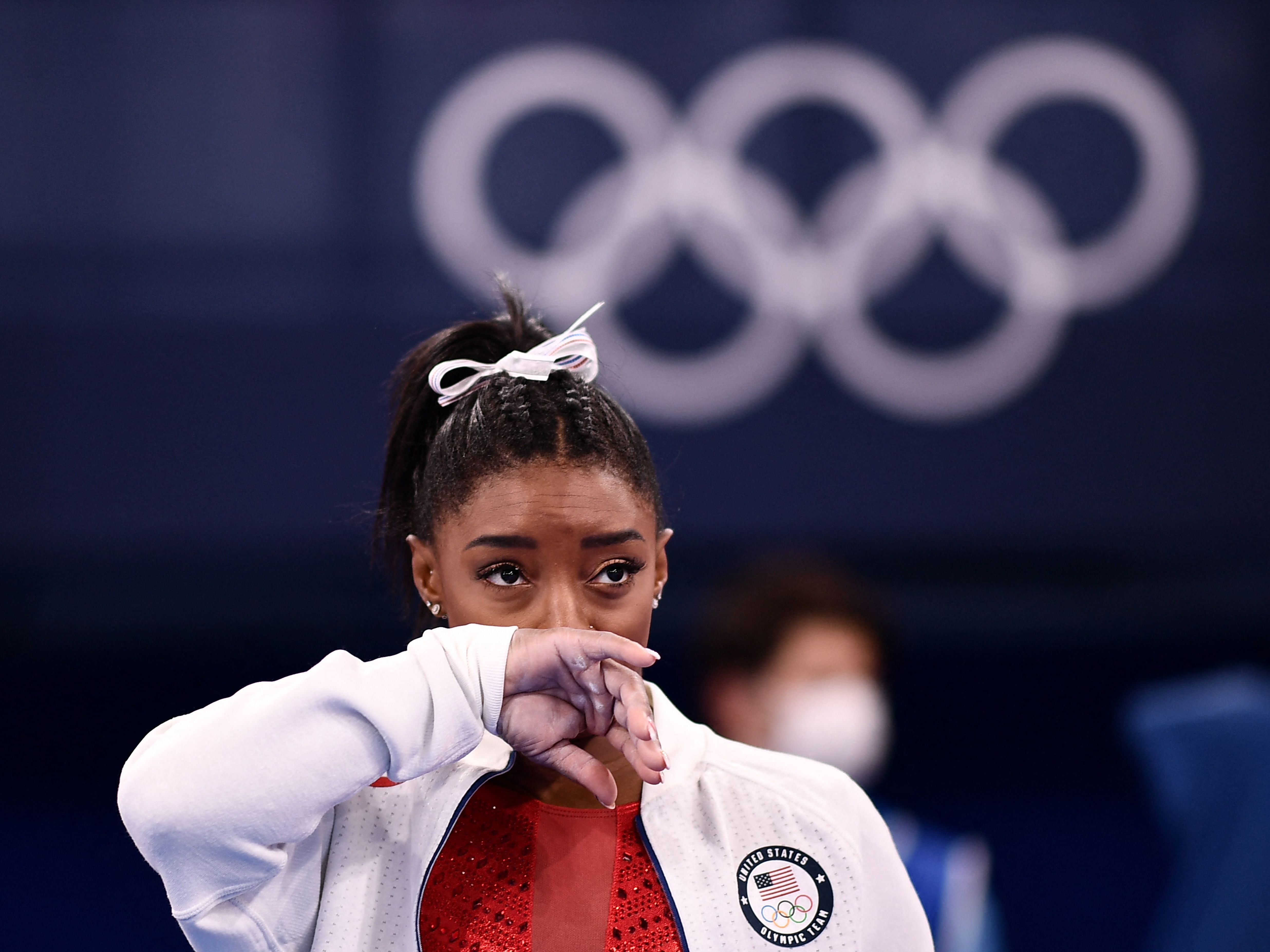 Simone Biles looks on during the women's gymnastics team final during the Tokyo Olympics on Tuesday. After competing on the vault, Biles withdrew from team competition. (AFP via Getty Images)