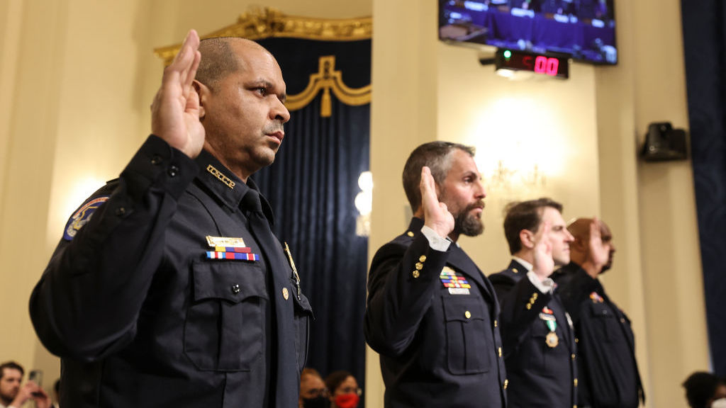 U.S. Capitol Police Sgt. Aquilino Gonell (from left), officers Michael Fanone and Daniel Hodges of the Washington, D.C., Metropolitan Police Department, and Capitol Police Pfc. Harry Dunn are sworn in Tuesday before testifying before the House select committee investigating the Jan. 6 attack. (Pool/Getty Images)