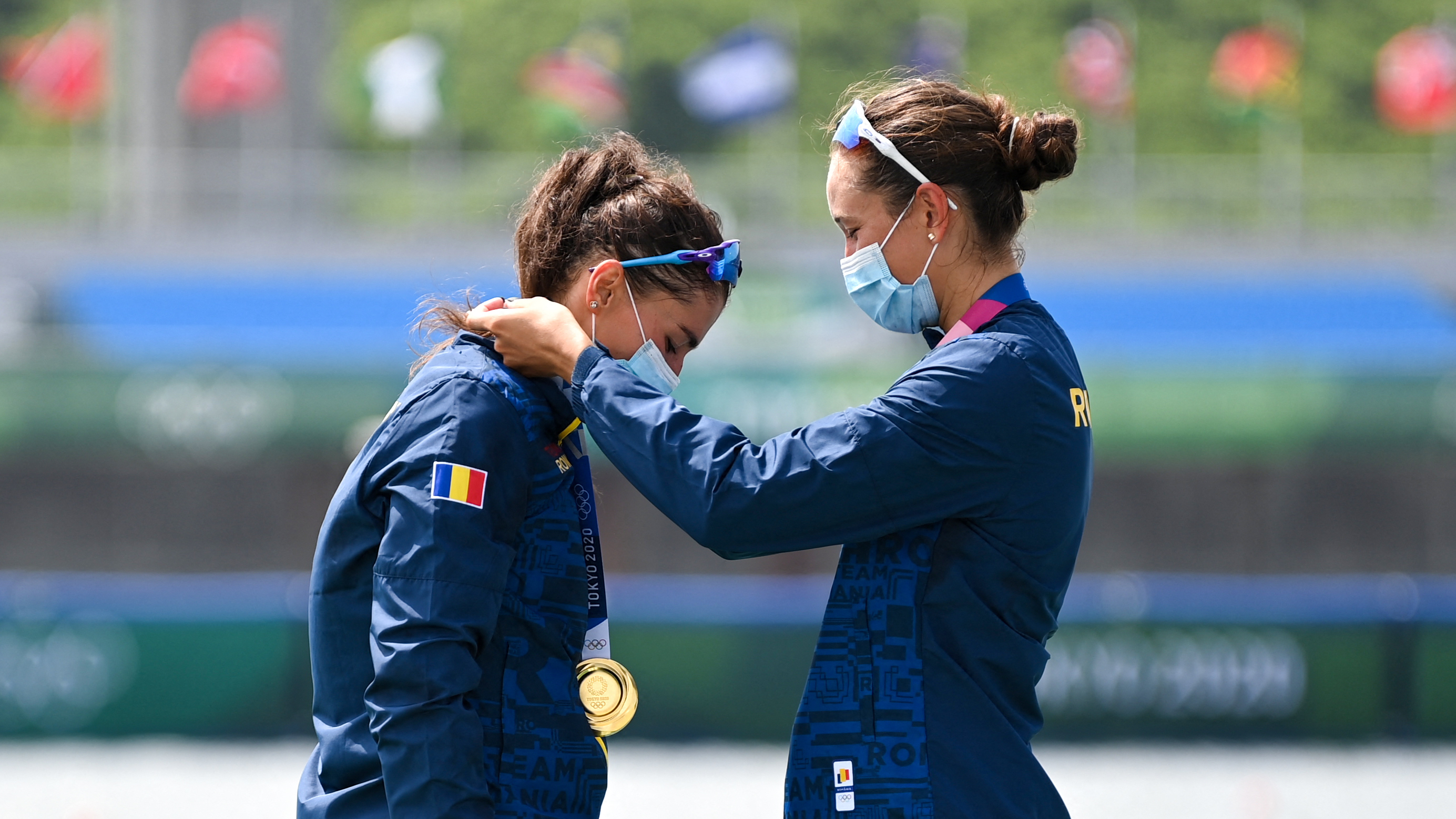 Gold medalists Ancuta Bodnar and Simona Radis of Romania celebrate on the podium following the women's double sculls final at the Tokyo Olympics on Wednesday. (AFP via Getty Images)