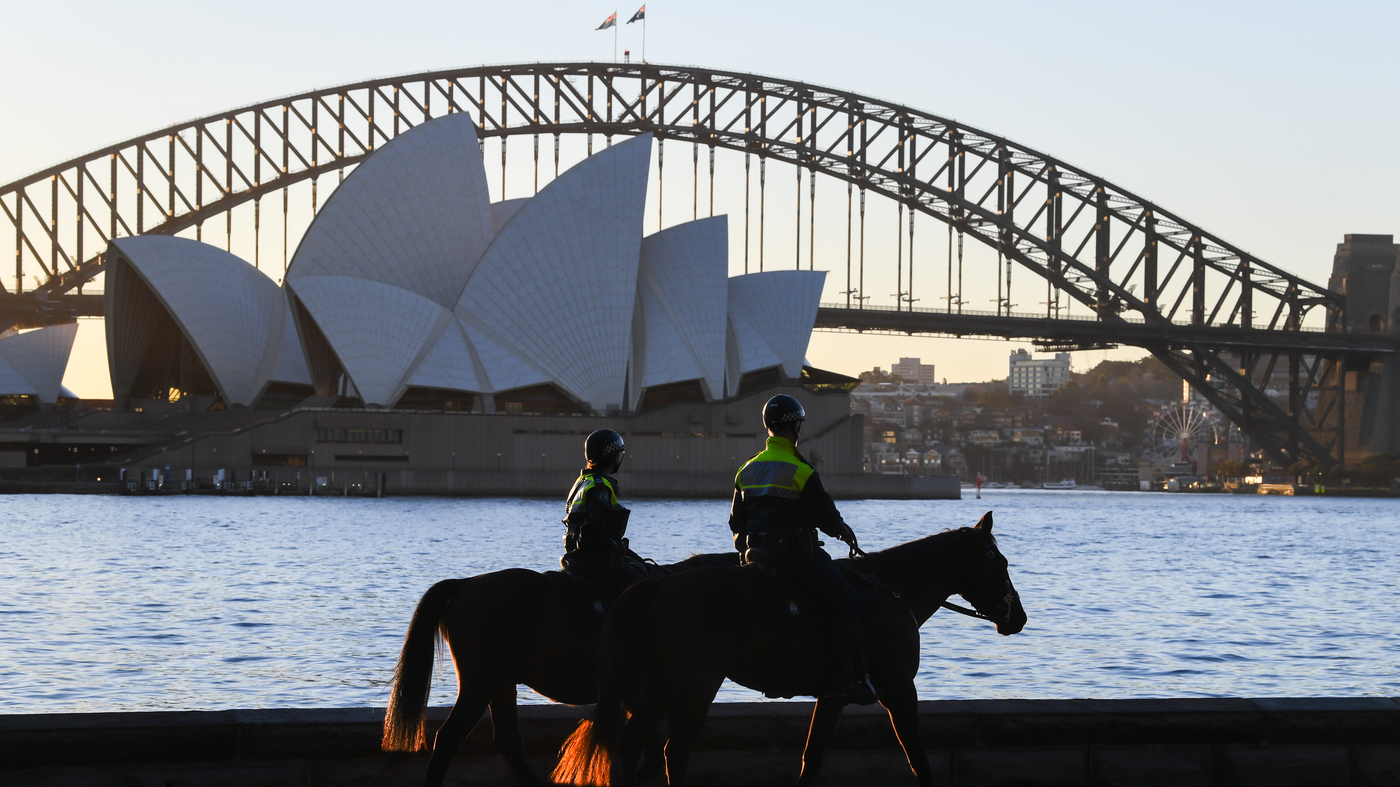                  Mounted police officers patrol around the edge of Sydney Harbor on Friday as the Australian city has been locked down amid a new surg