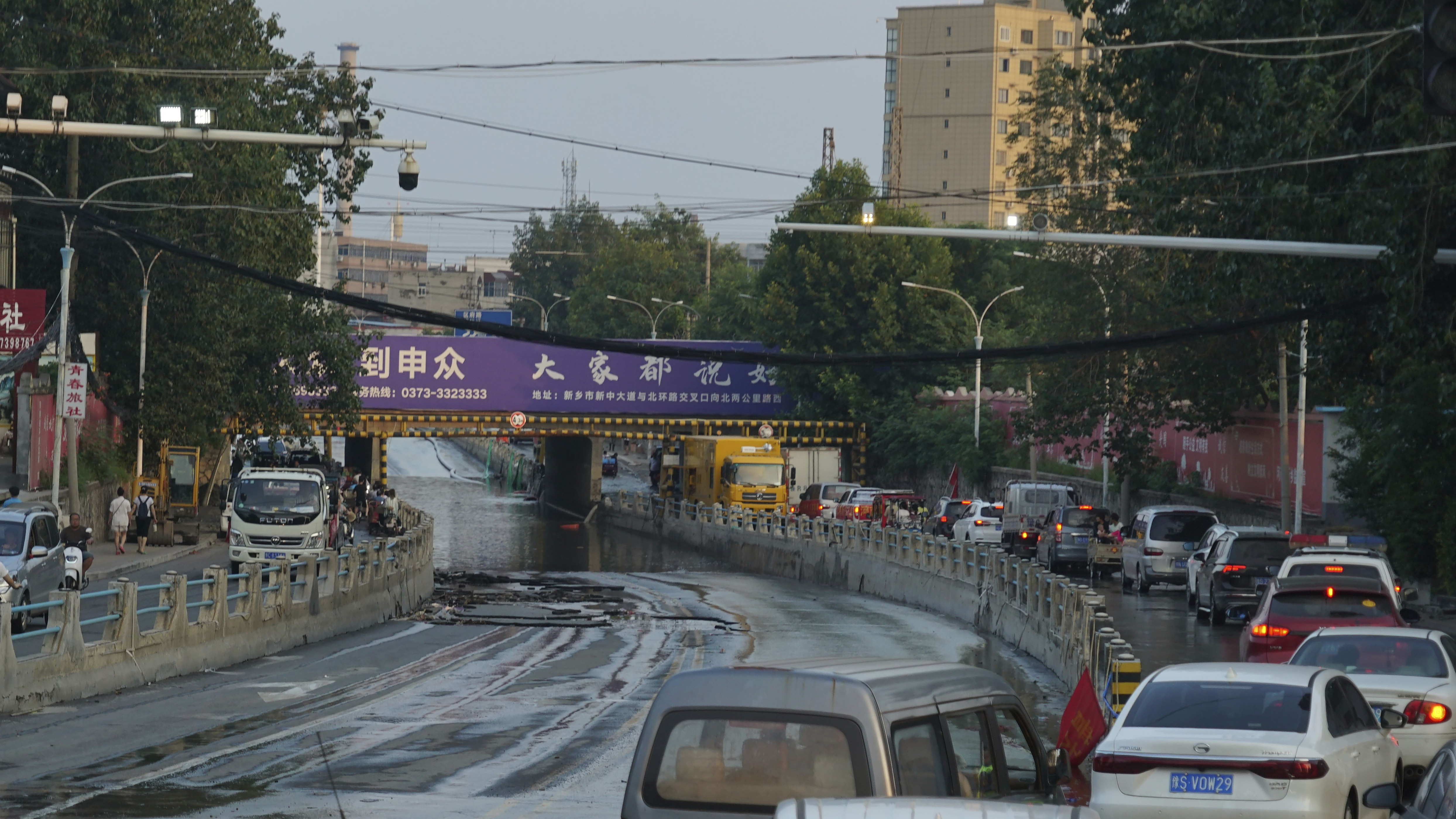 Trucks carrying water and food on Sunday streamed into Xinxiang, one of the cities struck by deadly flooding in China.