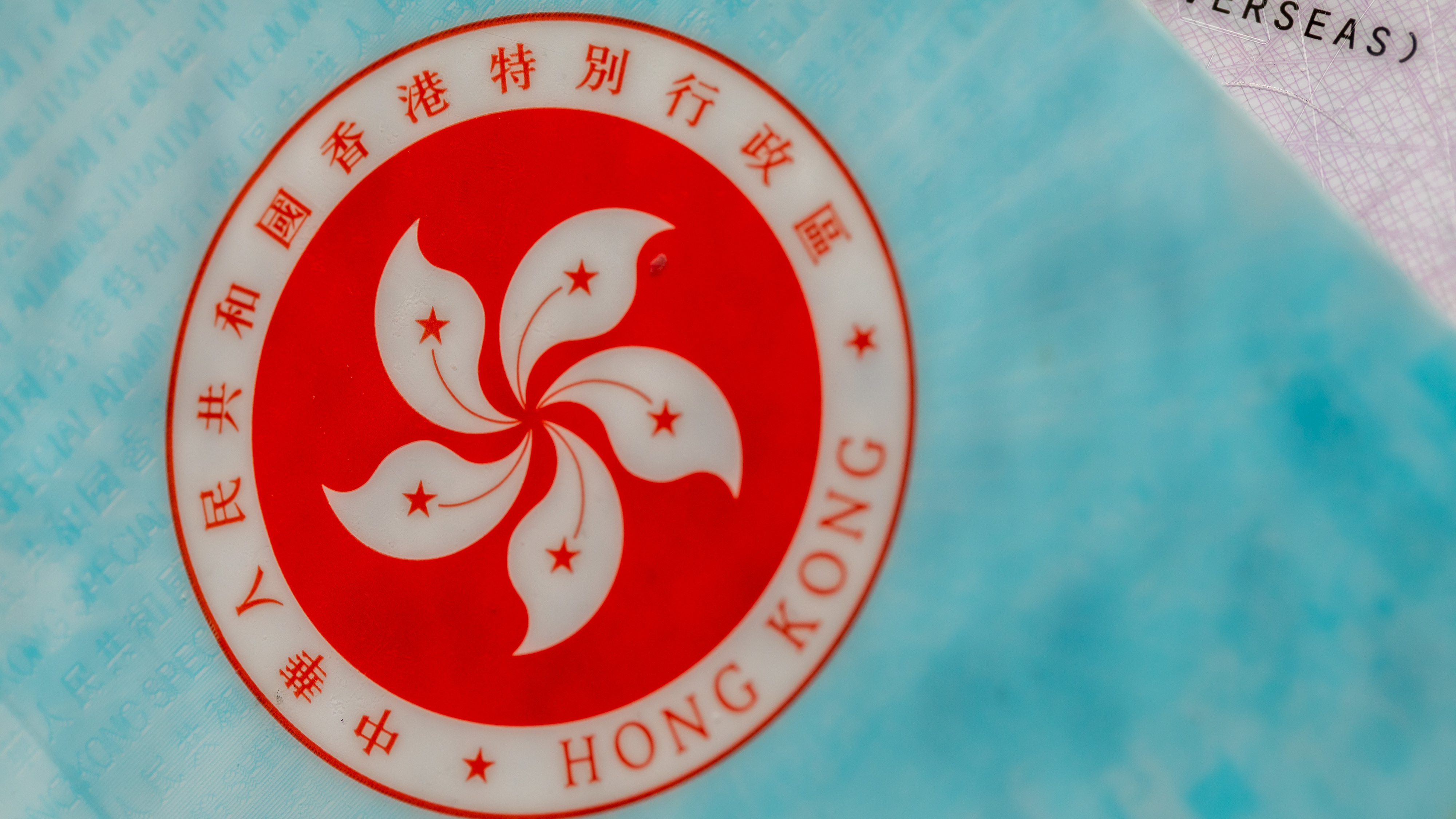 The Hong Kong Special Administrative Region (HKSAR) emblem on a page of the HKSAR passport arranged in Hong Kong, China, earlier this year. The Biden administration says it will allow Hong Kong residents to remain and work in the U.S. for at least 18 months without fear of deportation.