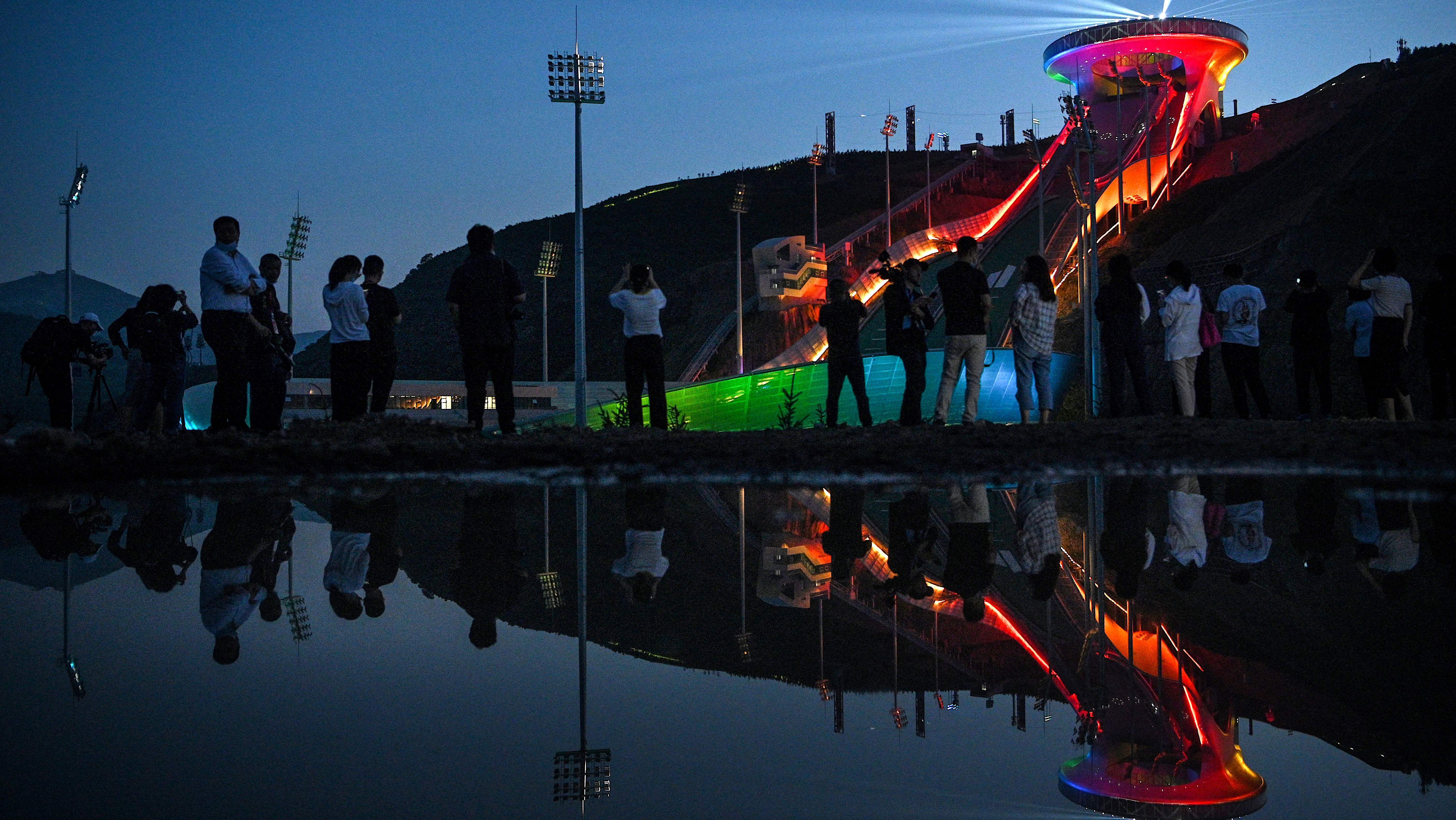 The Beijing Winter Olympics are set to open in February. Visitors recently watched a light show at the newly built ski jumping center in northern China's Hebei province.