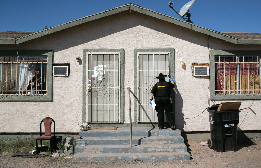 Maricopa County constable Darlene Martinez knocks on a door before posting an eviction order on Oct. 1, 2020, in Phoenix. An extended eviction moratorium ordered by the Centers for Disease Control and Prevention has been struck down. (Getty Images)