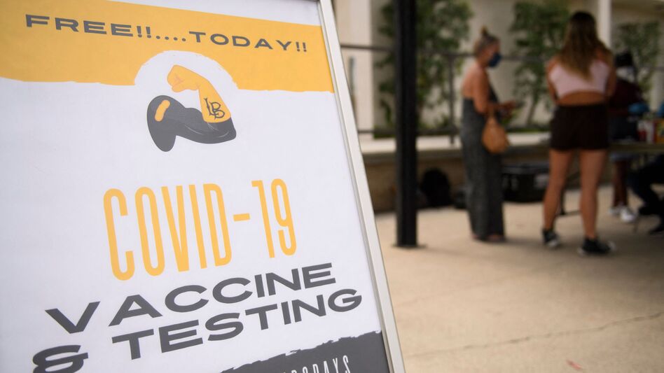 COVID-19 vaccine and testing signage is displayed at a City of Long Beach mobile vaccination clinic at California State University, Long Beach, campus on Wednesday in California. (Patrick T. Fallon/AFP via Getty Images)