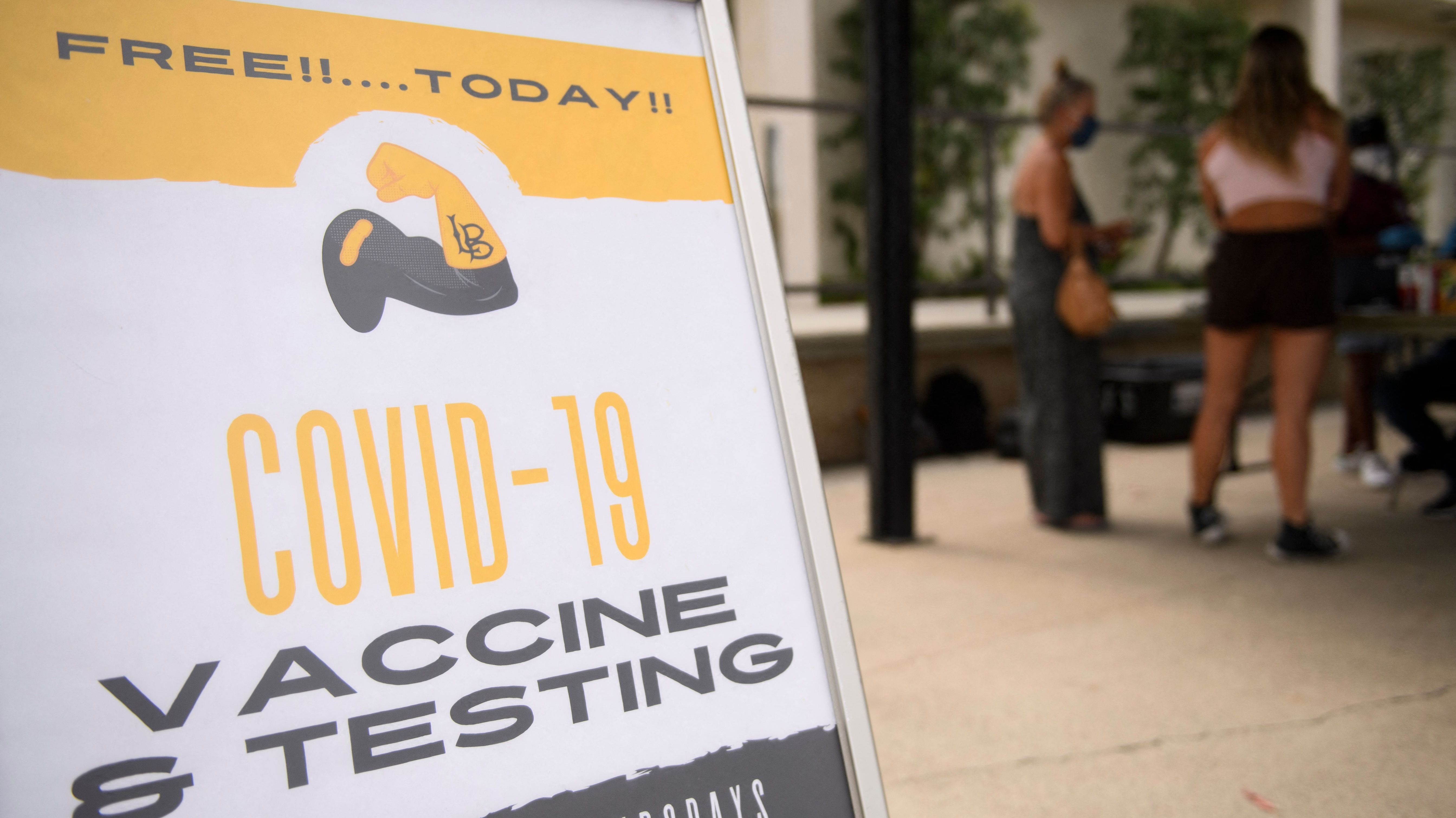 COVID-19 vaccine and testing signage is displayed at a City of Long Beach mobile vaccination clinic at California State University, Long Beach, campus on Wednesday in California. (AFP via Getty Images)