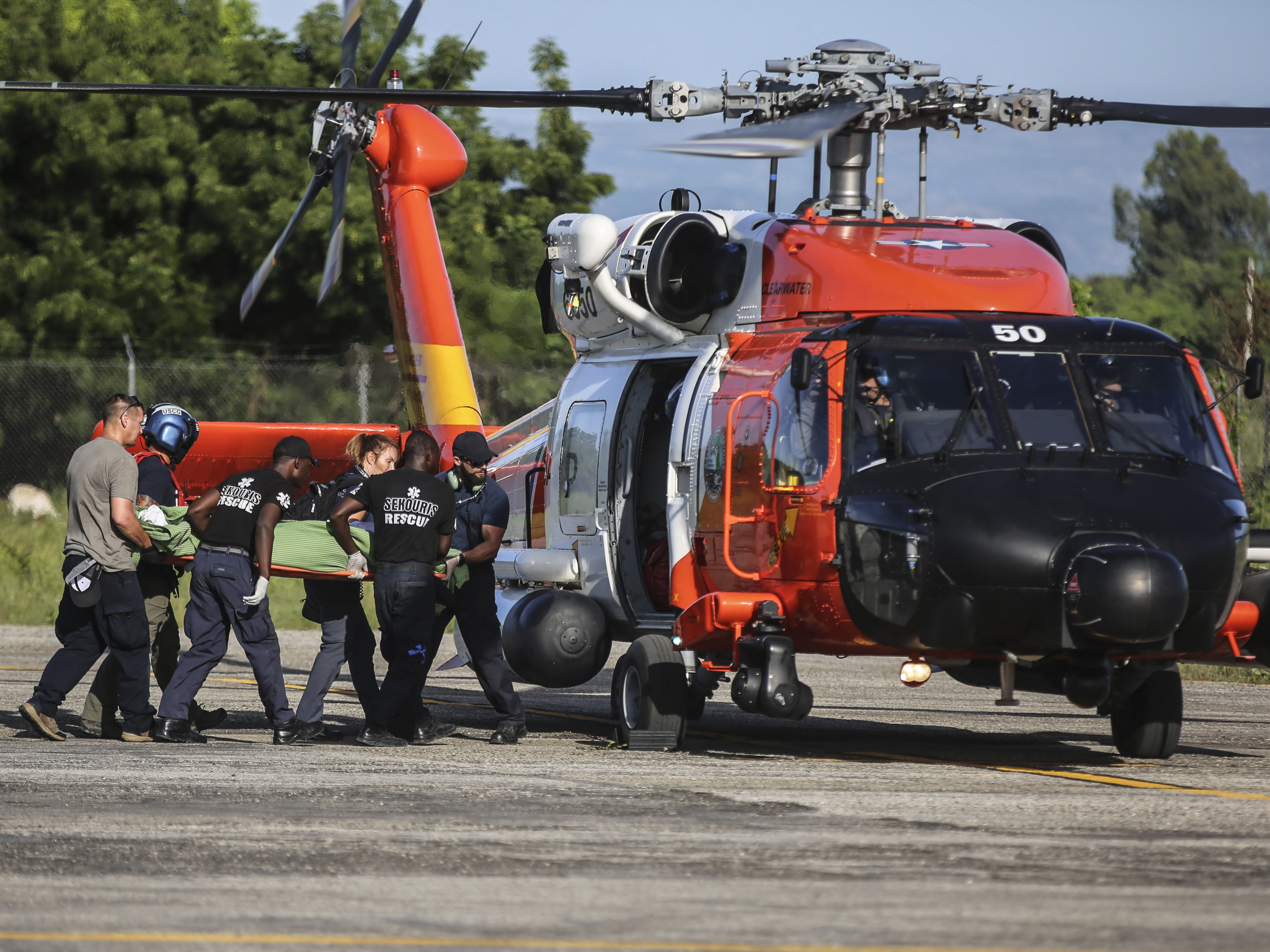 A person injured in the earthquake is transferred to a US Coast Guard helicopter in Les Cayes, Haiti, Monday, Aug. 16, 2021, two days after a 7.2-magnitude earthquake struck the southwestern part of the country. (Joseph Odelyn/AP)