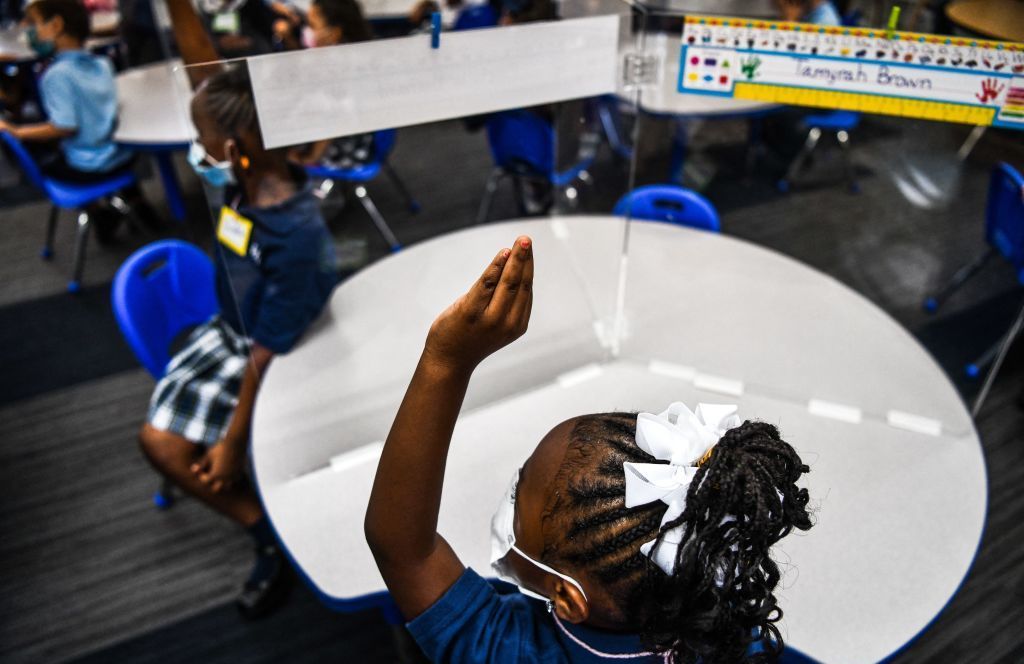 Student wear facemasks as they attend their first day in school after summer vacation at the St. Lawrence Catholic School north of Miami on Wednesday. (AFP via Getty Images)