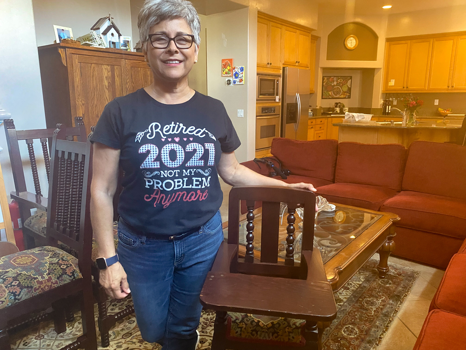 Norma Jasso, 62, sped up retirement plans after her daughter asked for help with a new baby. She stands with a highchair her father had commissioned from a shop in Sinaloa, Mexico. Her daughters used it and now her grandson will too. (Andrea Hsu/NPR)