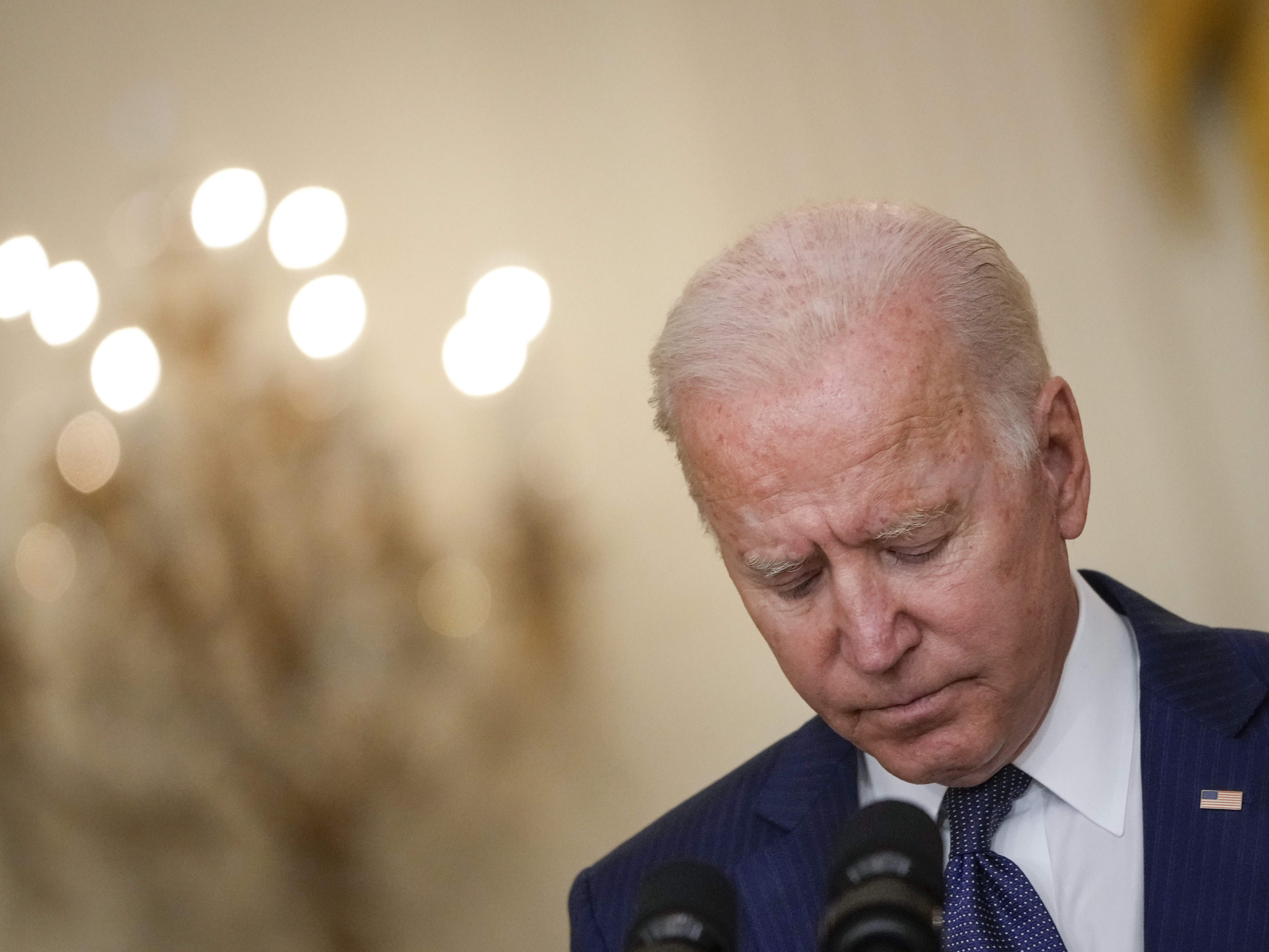 President Biden bows his head in a moment of silence Thursday as he speaks about the situation in Afghanistan from the White House's East Room. (Getty Images)