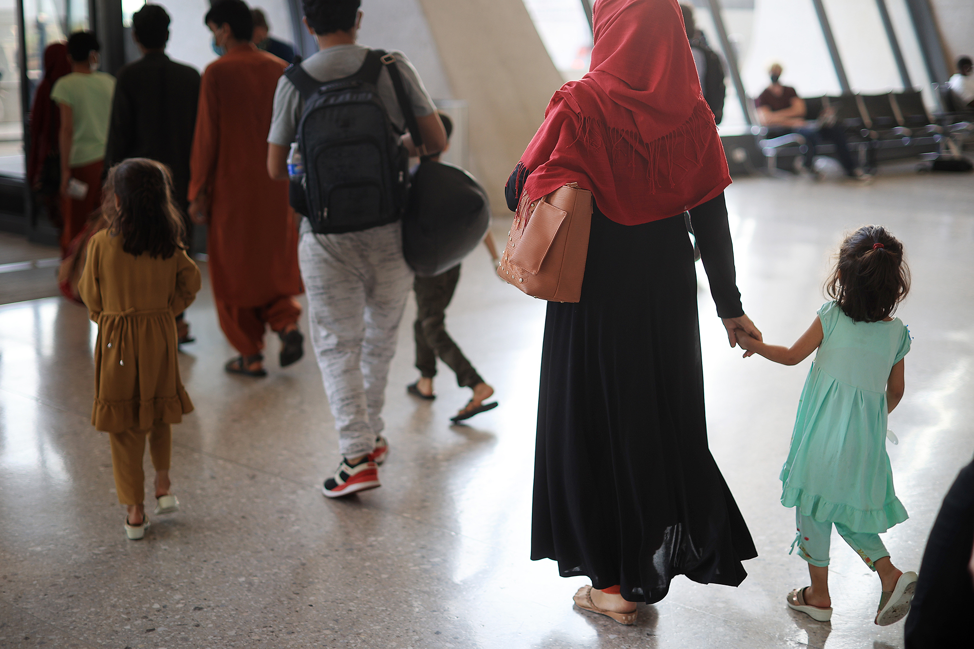 Refugees arrive at Dulles International Airport in Virginia on Friday after being evacuated from Kabul following the Taliban takeover of Afghanistan. (Getty Images)
