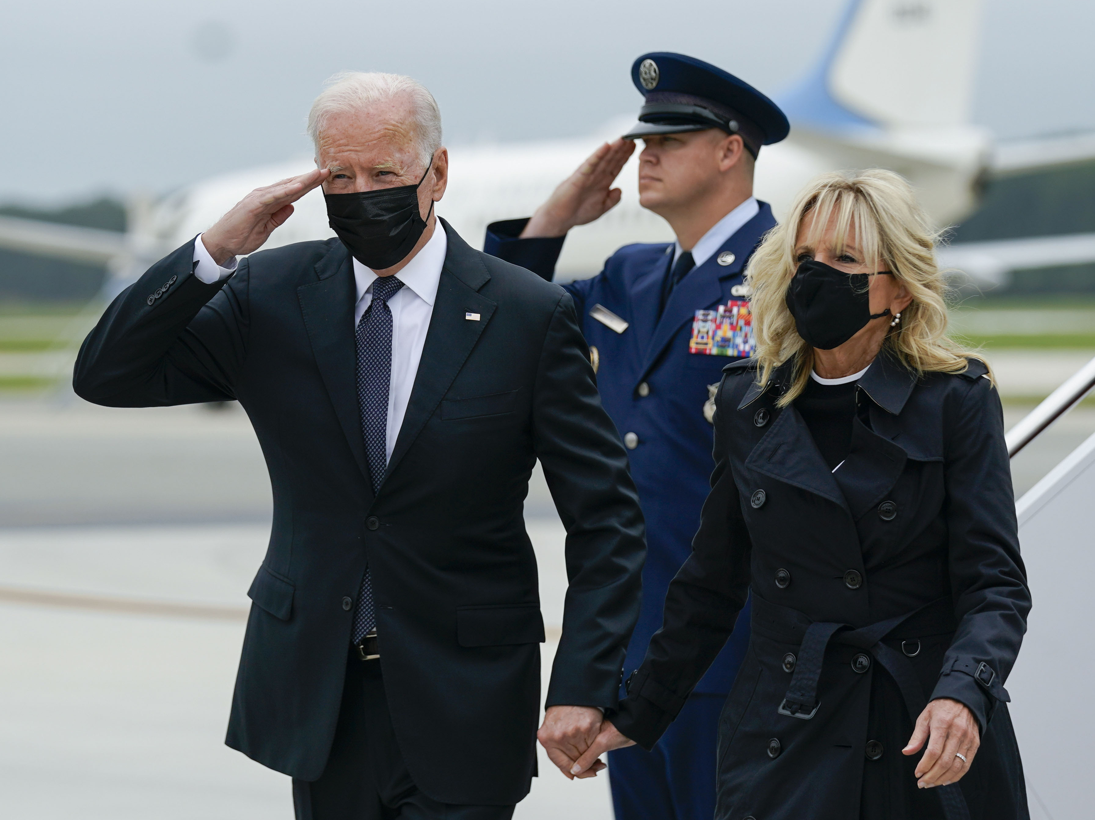 President Biden returns a salute as he and first lady Jill Biden arrive at Dover Air Force Base, Del., Sunday, Aug. 29, 2021. Biden embarked on a solemn journey Sunday to honor and mourn the 13 U.S. troops killed in the suicide attack near the Kabul airport as their remains return to U.S. (Manuel Balce Ceneta/AP)
