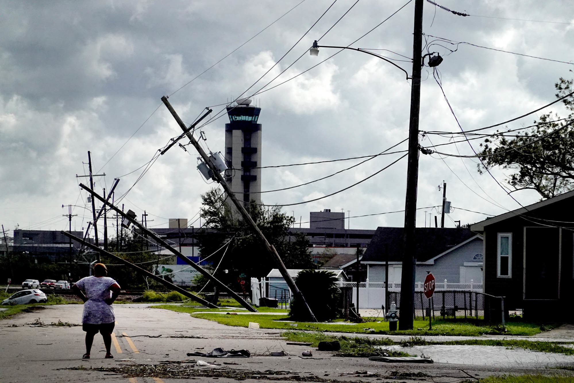 Mon., Aug. 30: A woman looks over damage to a neighborhood caused by Hurricane Ida in Kenner, La.
