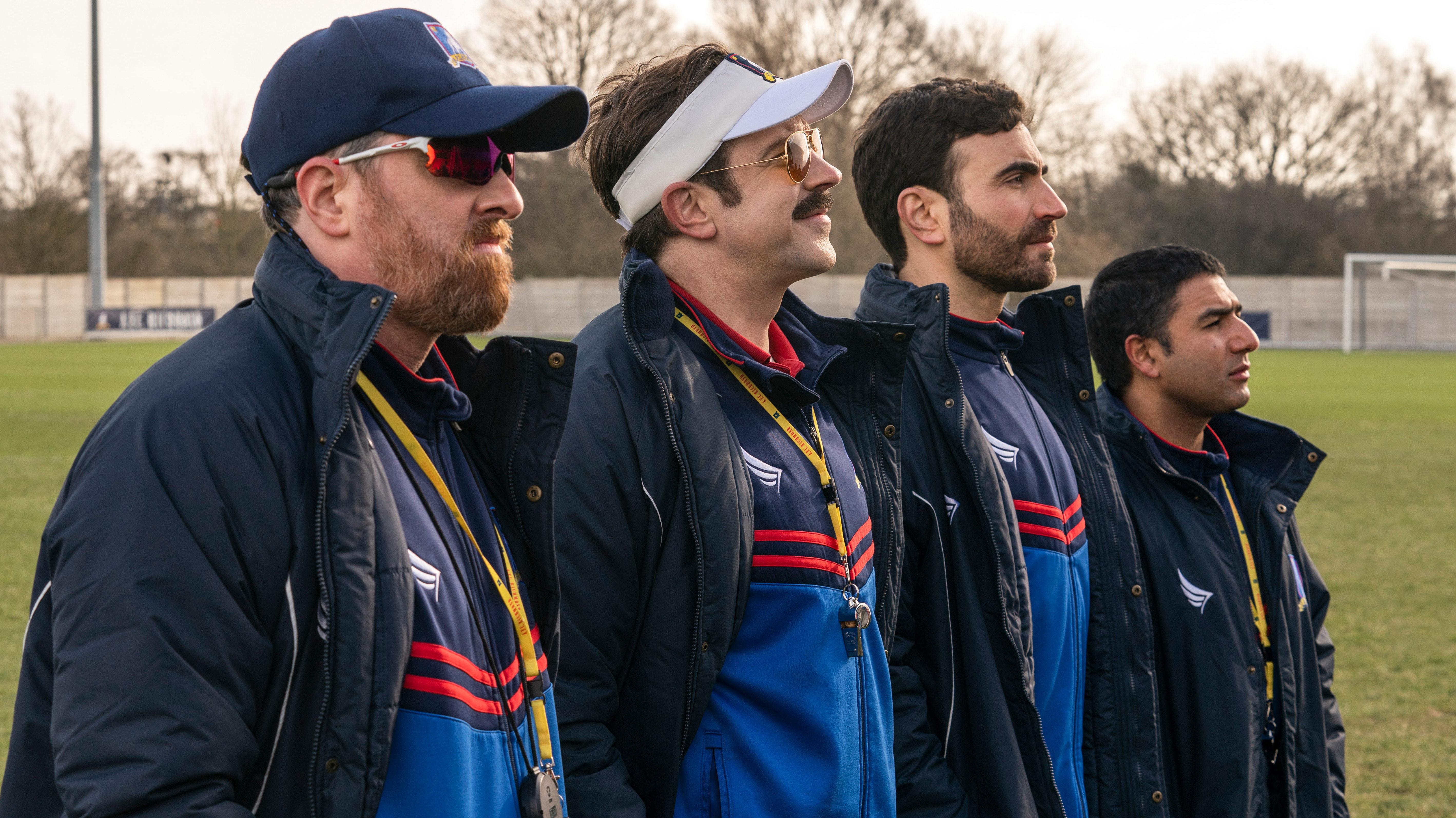 Brendan Hunt, Jason Sudeikis, Brett Goldstein, and Nick Mohammed play a coaching staff in flux. (Apple TV+)