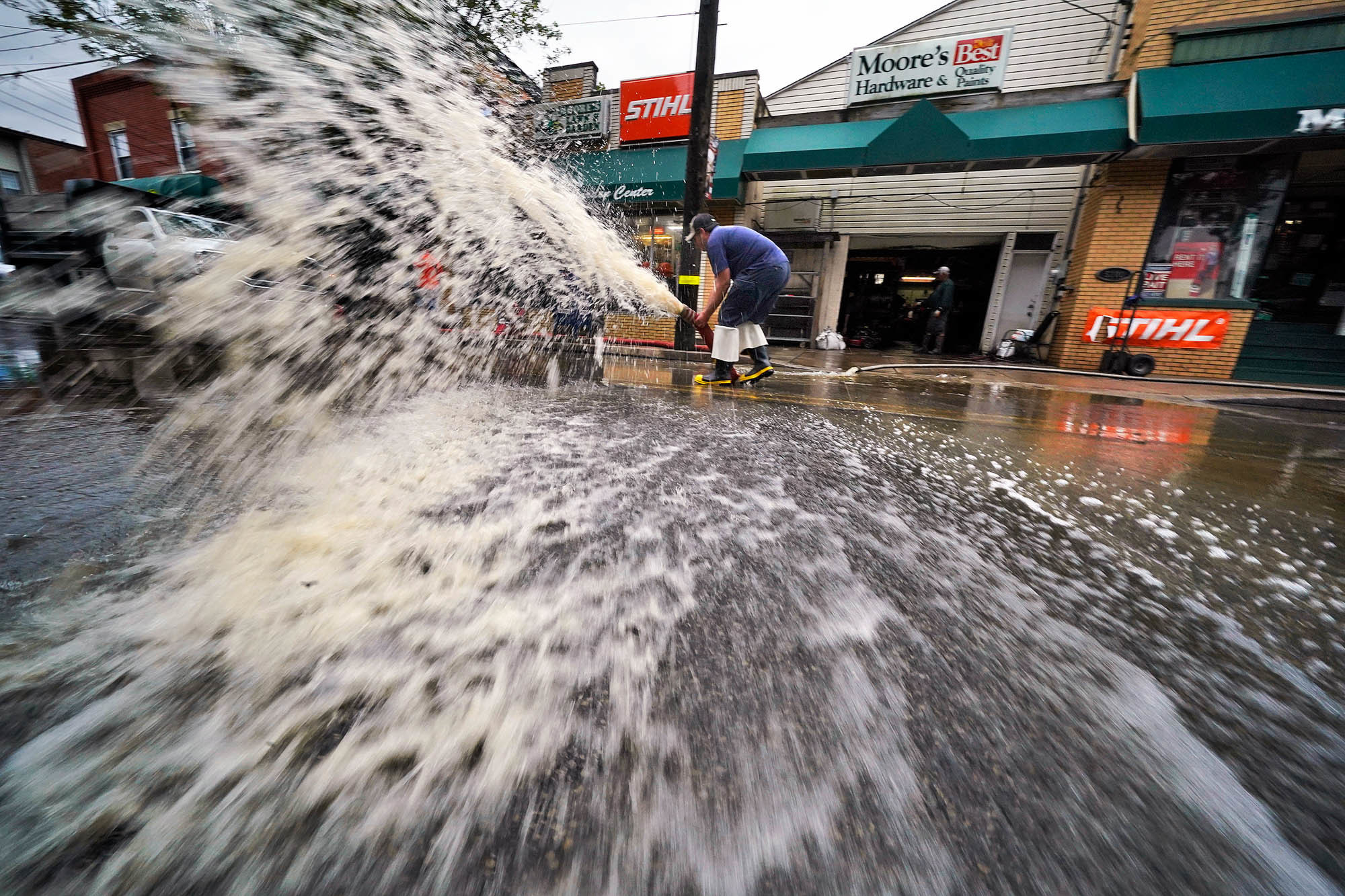 Wednesday., Sept. 1: Water is pumped from the basement of a business on Noblestown road in Oakdale, Pa., during clean up from flooding after downpours and high winds from the remnants of Hurricane Ida.