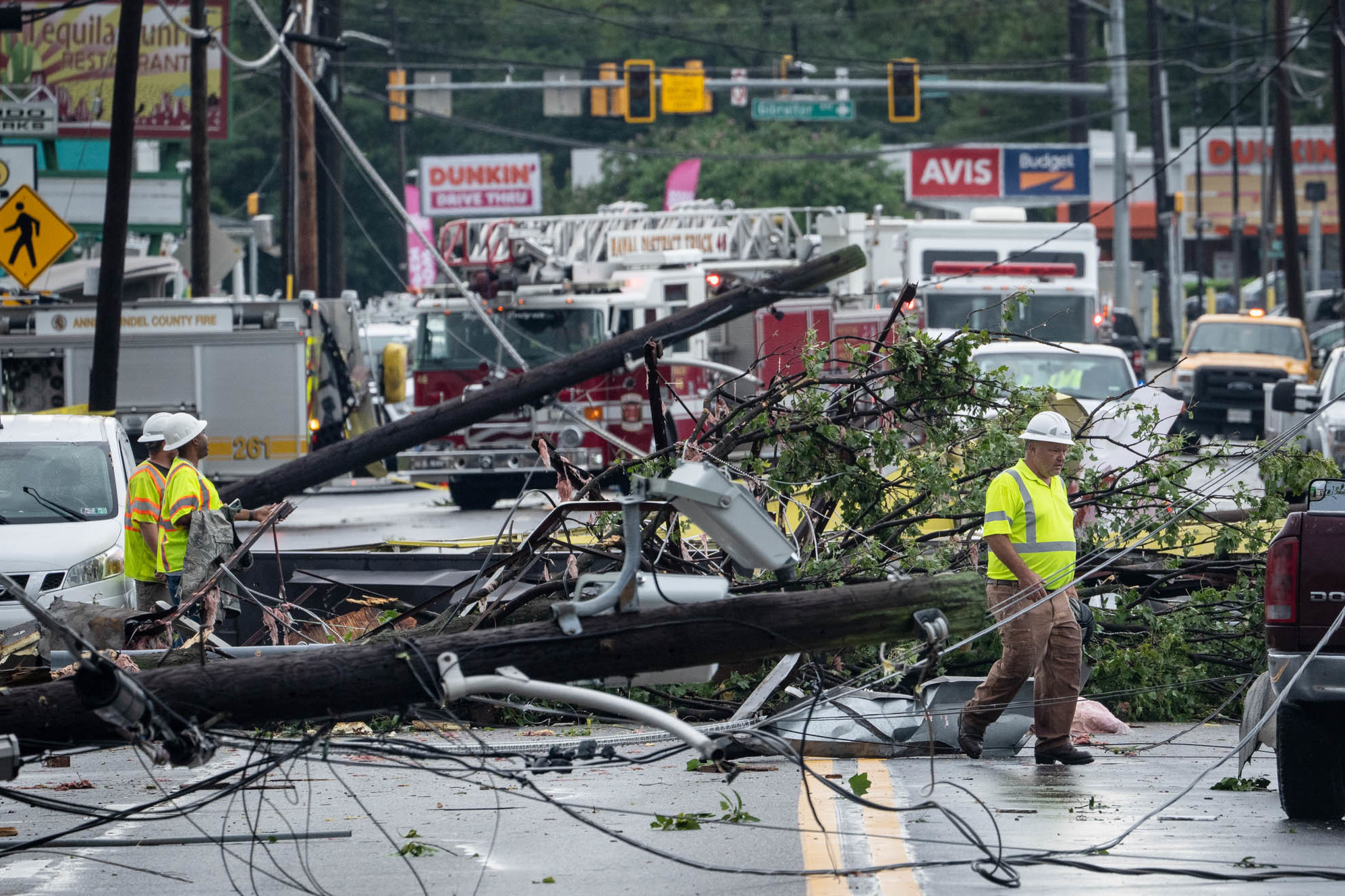 Wednesday., Sept. 1: Comcast utility workers survey the damage from a tornado on West Street in Annapolis, Maryland.