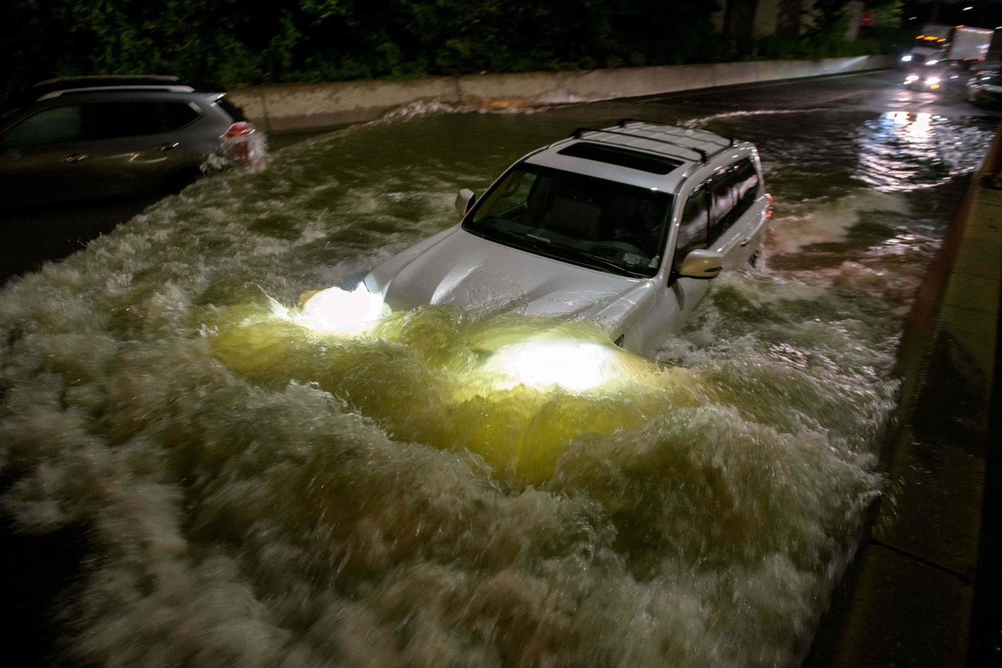Thursday., Sept. 2: A motorist drives a car through a flooded expressway in Brooklyn, New York early on September 2, 2021, as flash flooding and record-breaking rainfall brought by the remnants of Storm Ida swept through the area.