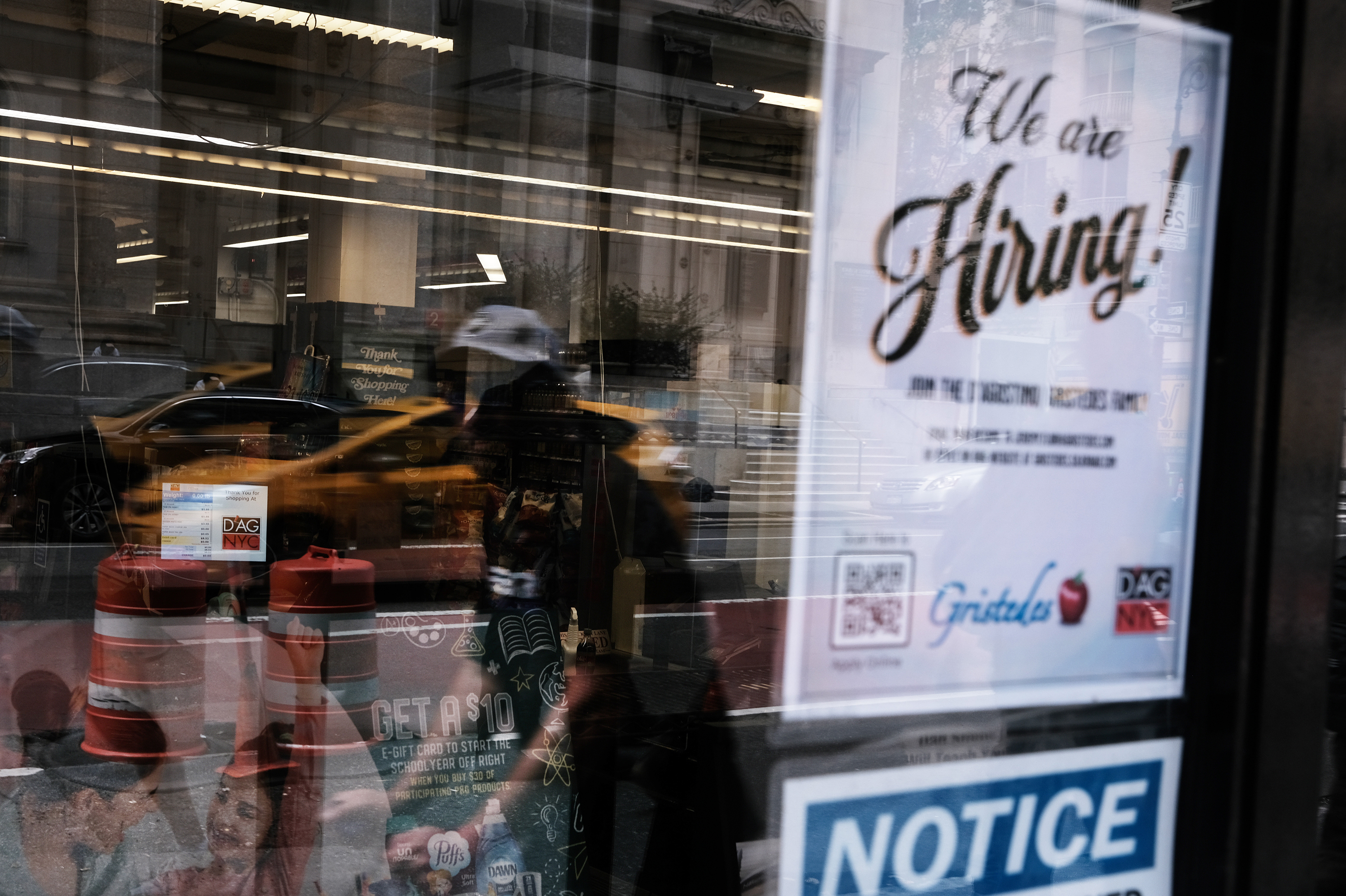 A hiring sign gets displayed in a store window in New York City in August. Last month saw a sharp slowdown in hiring from previous months as the pandemic wears on and creates uncertainty. (Getty Images)