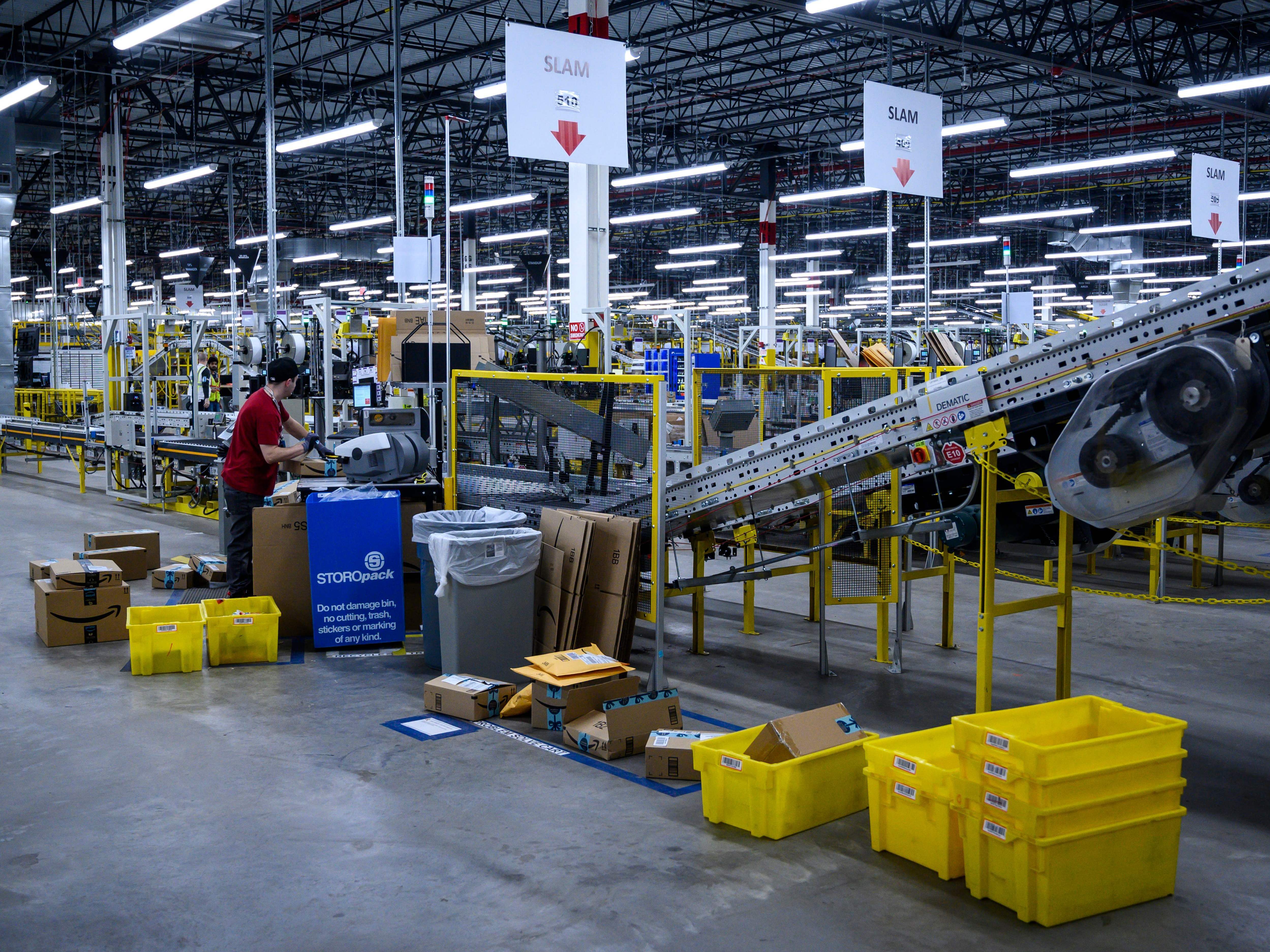 A man works at a conveyor belt at an Amazon warehouse in New York City in 2019. (AFP/Getty Images)