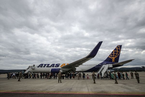 Afghan evacuees line up at the U.S. air base in Ramstein, Germany, on Aug. 26. After leaving Afghanistan, refugees traveled through the Middle East before arriving at one of several U.S. bases in Europe.