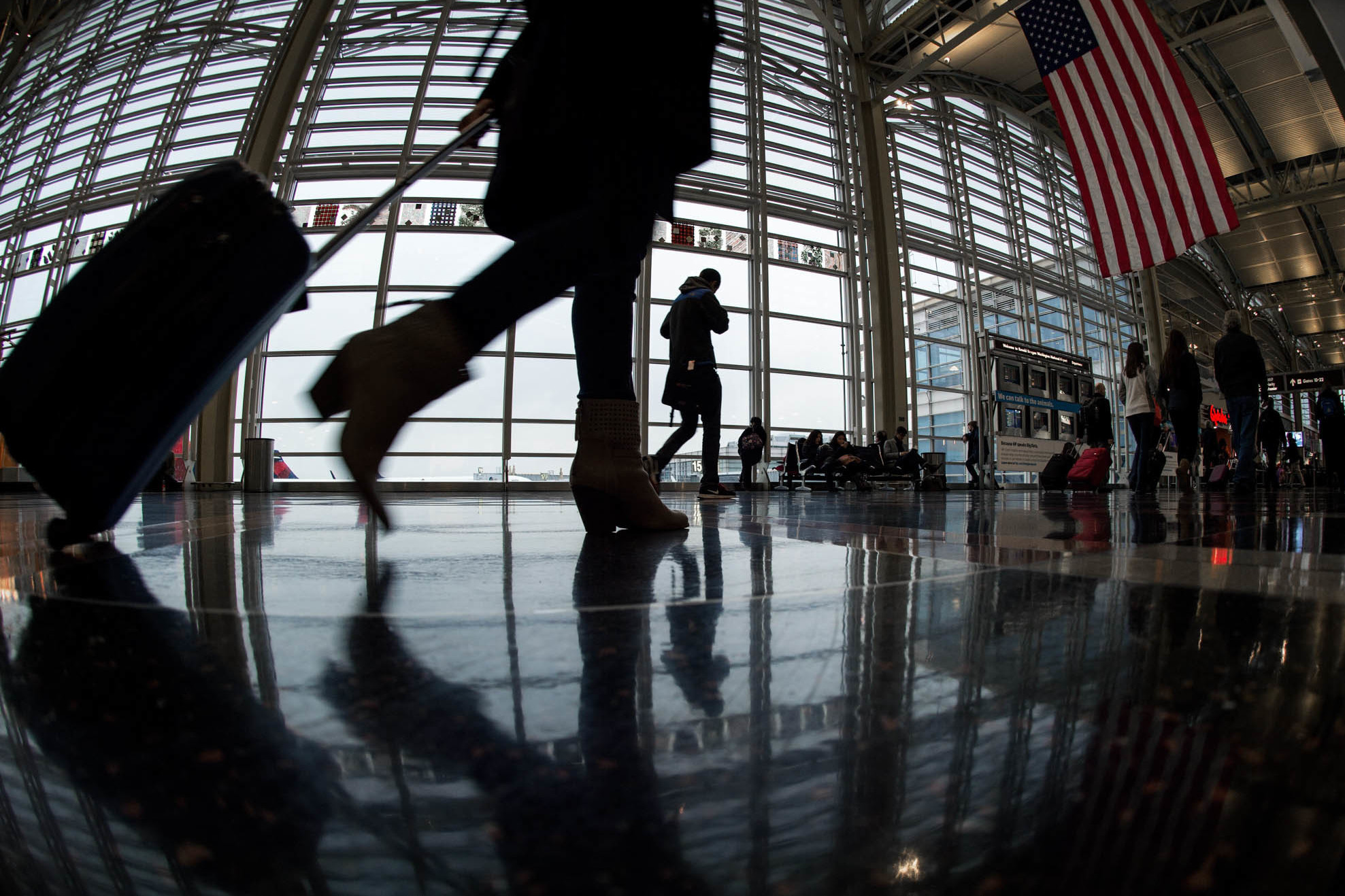 A traveler at Ronald Reagan Washington National Airport walks to a Transportation Security Administration checkpoint on Nov. 26, 2014. (AFP via Getty Images)