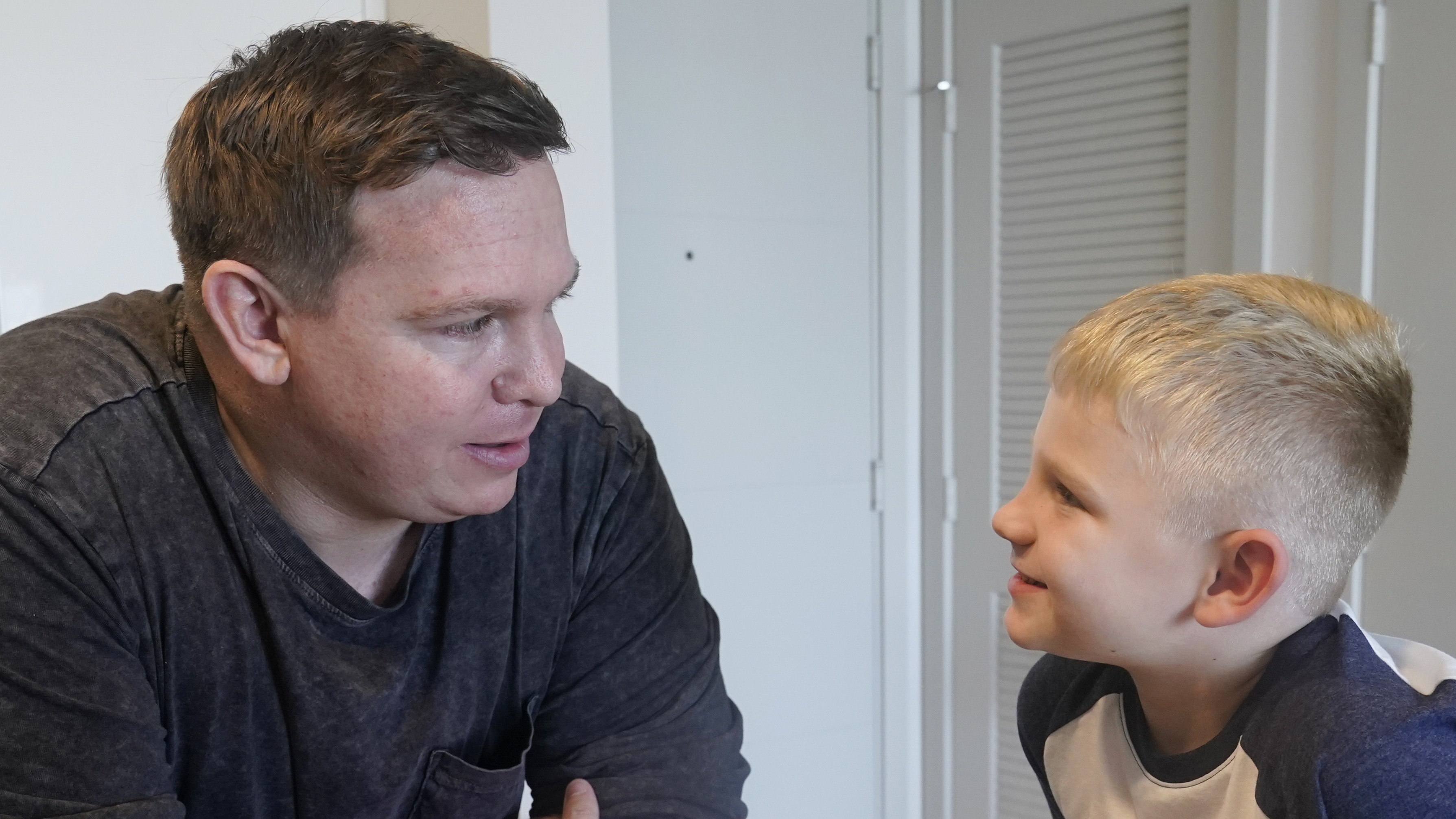 Associated Press investigative reporter James LaPorta and his son Joel, 5, sit at their home on Tuesday in Boca Raton, Fla. LaPorta recalls a boy he encountered in Afghanistan in 2013 while serving as a Marine.
