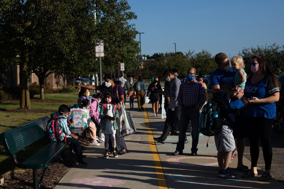 Parents drop their children off for the first day of school in Novi, Mich., on Tuesday. (Emily Elconin/Bloomberg/Getty Images)
