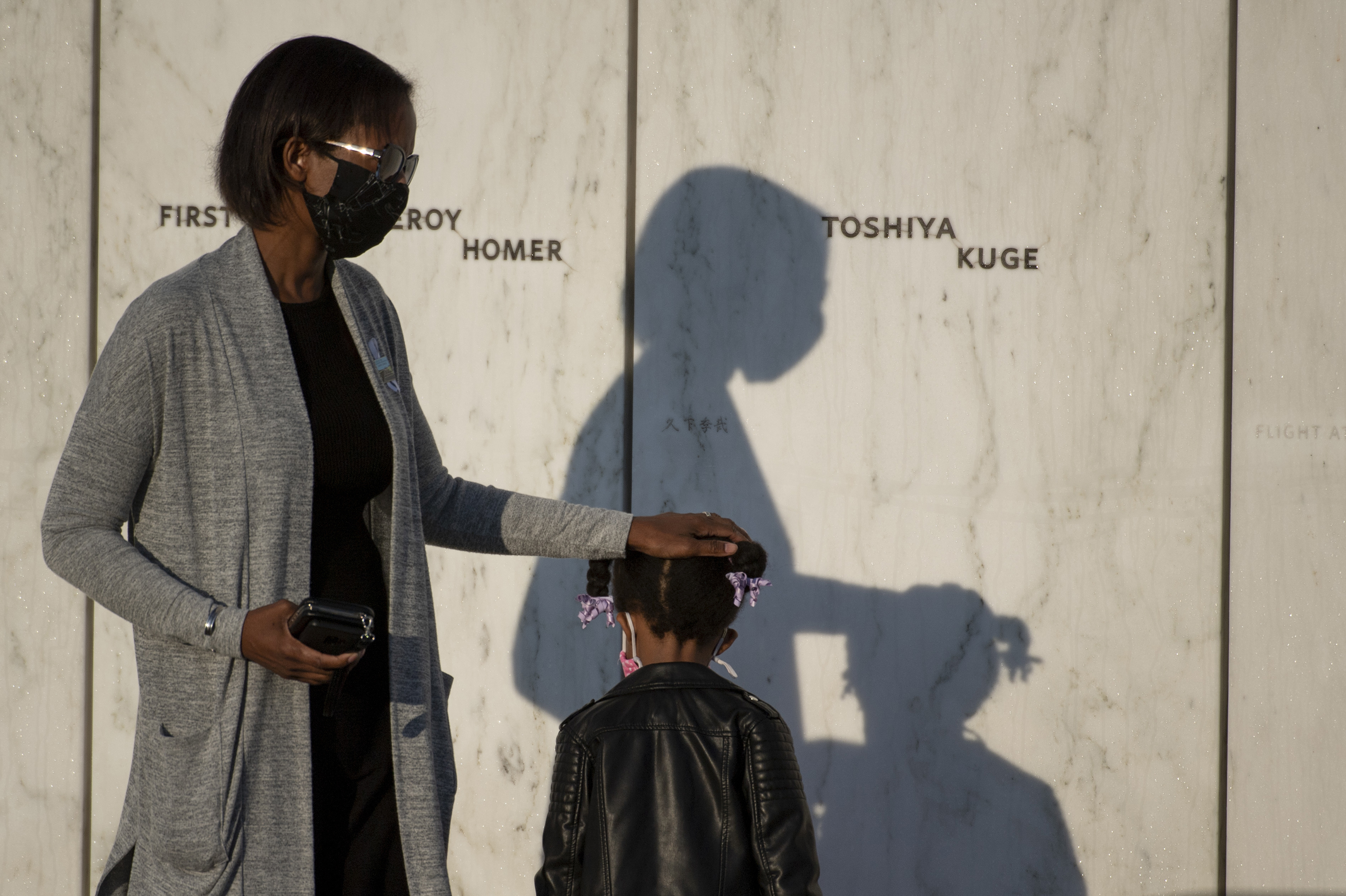 Photos: Scenes From 9/11 National Memorials 12 An attendee puts her hand on the head of a child at the Flight 93 National Memorial in Shanksville.