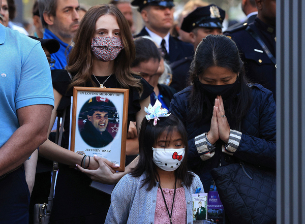 Family members and loved ones of victims of those who died on 9/11 attend the 20th anniversary commemoration ceremony on Saturday at the National September 11 Memorial & Museum in New York City.