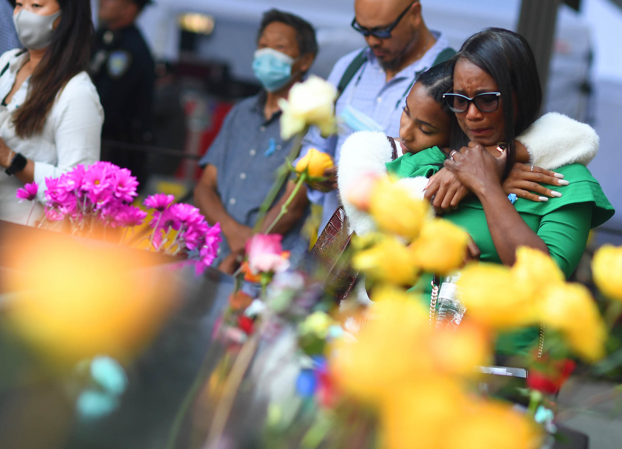 Danielle Booker hugs her mother, Sharon Booker, as the two remember Sean Booker, Danielle's father and Sharon's husband, at the National September 11 Memorial & Museum during a ceremony on Saturday in Manhattan. Sean Booker was a technician on the 93rd floor of the World Trade Center's north tower when he was killed during the 2001 attacks. (Denver Post via Getty Images)