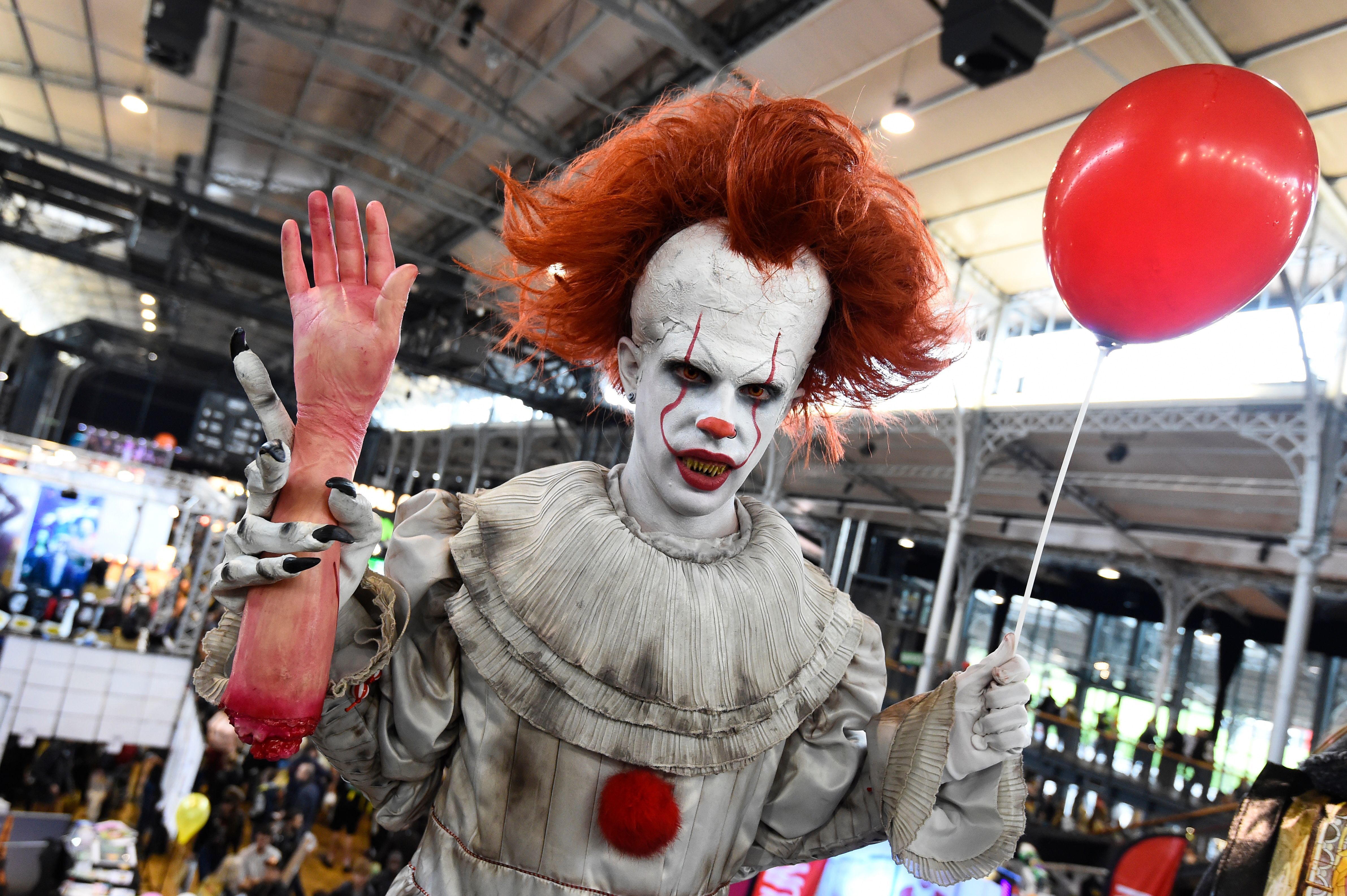 A cosplayers dressed as Pennywise from &quot;It&quot; poses during the Comic Con festival in 2017 at the Grande Halle de la Villette in Paris. (AFP via Getty Images)