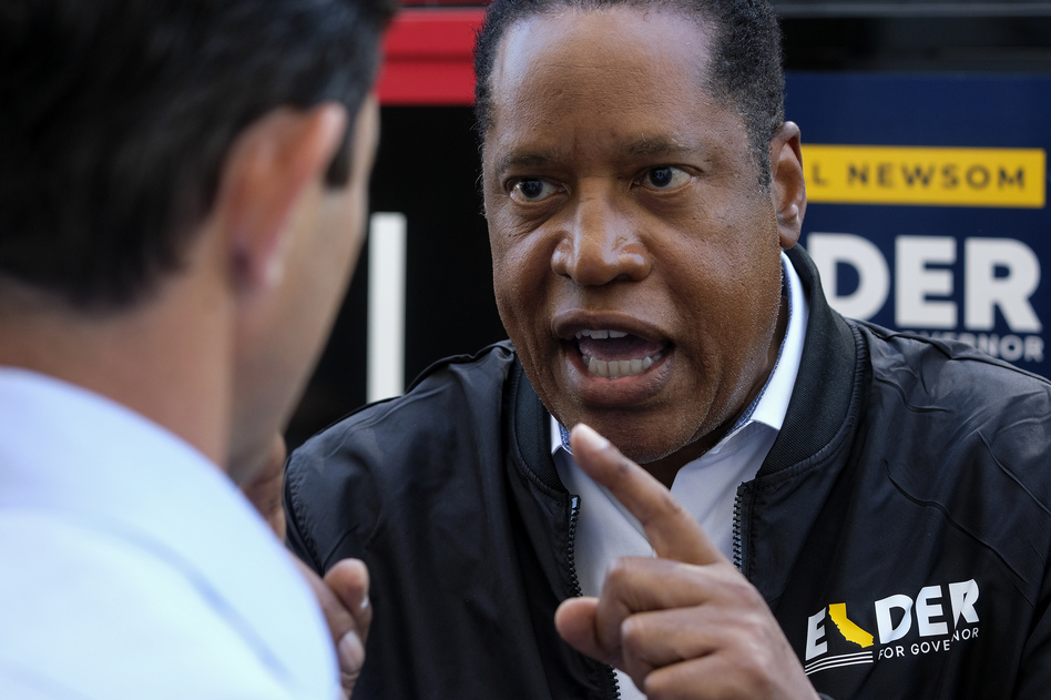 Republican conservative radio show host Larry Elder argues with a TV reporter in an interview Monday after visiting Philippe the Original deli during the campaign for the California gubernatorial recall election in Los Angeles.