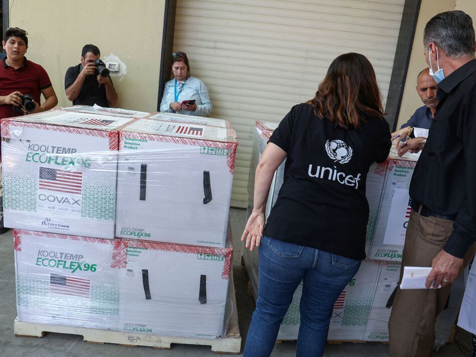 Palestinian Health Ministry staff members in Nablus receive 300,000 doses of COVID-19 vaccines donated by the United States through through the COVAX vaccine-sharing initiative on Aug. 24, 2021. (Jaafar Ashtiyeh/AFP via Getty Images)