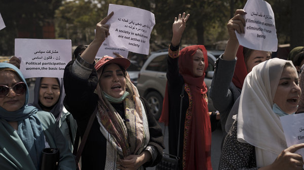 Women march to demand their rights under the Taliban rule during a demonstration near the former Women