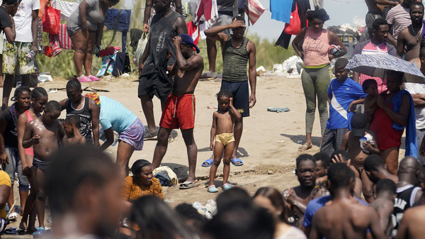 Haitian migrants gather on the banks of the Rio Grande on Saturday after they crossed into the United States from Mexico.