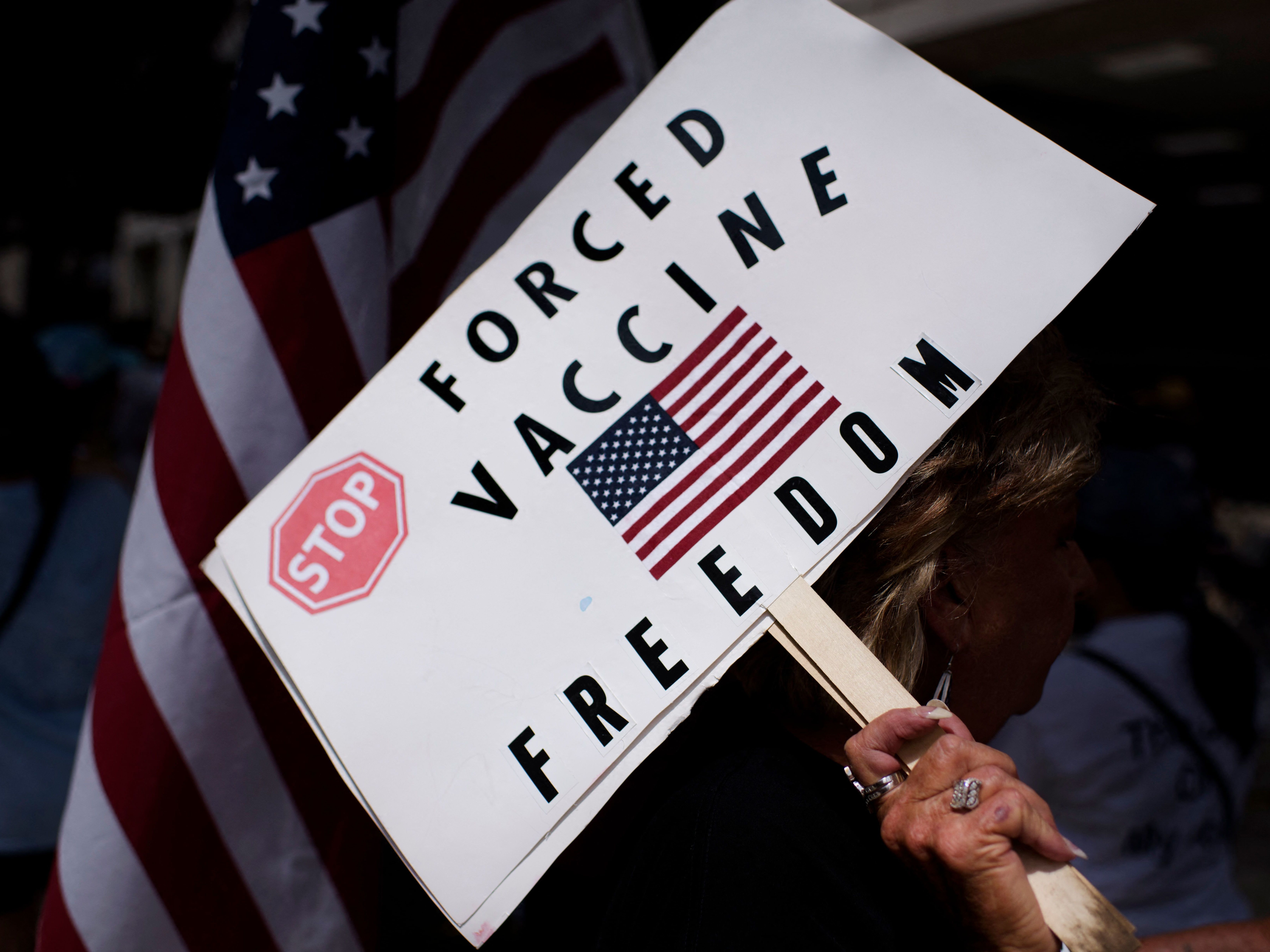 Vaccine protesters hold signs outside Houston Methodist Hospital in Houston, Texas, on June 26. More than 150 employees either quit or were fired for declining the vaccine. (AFP /AFP via Getty Images)