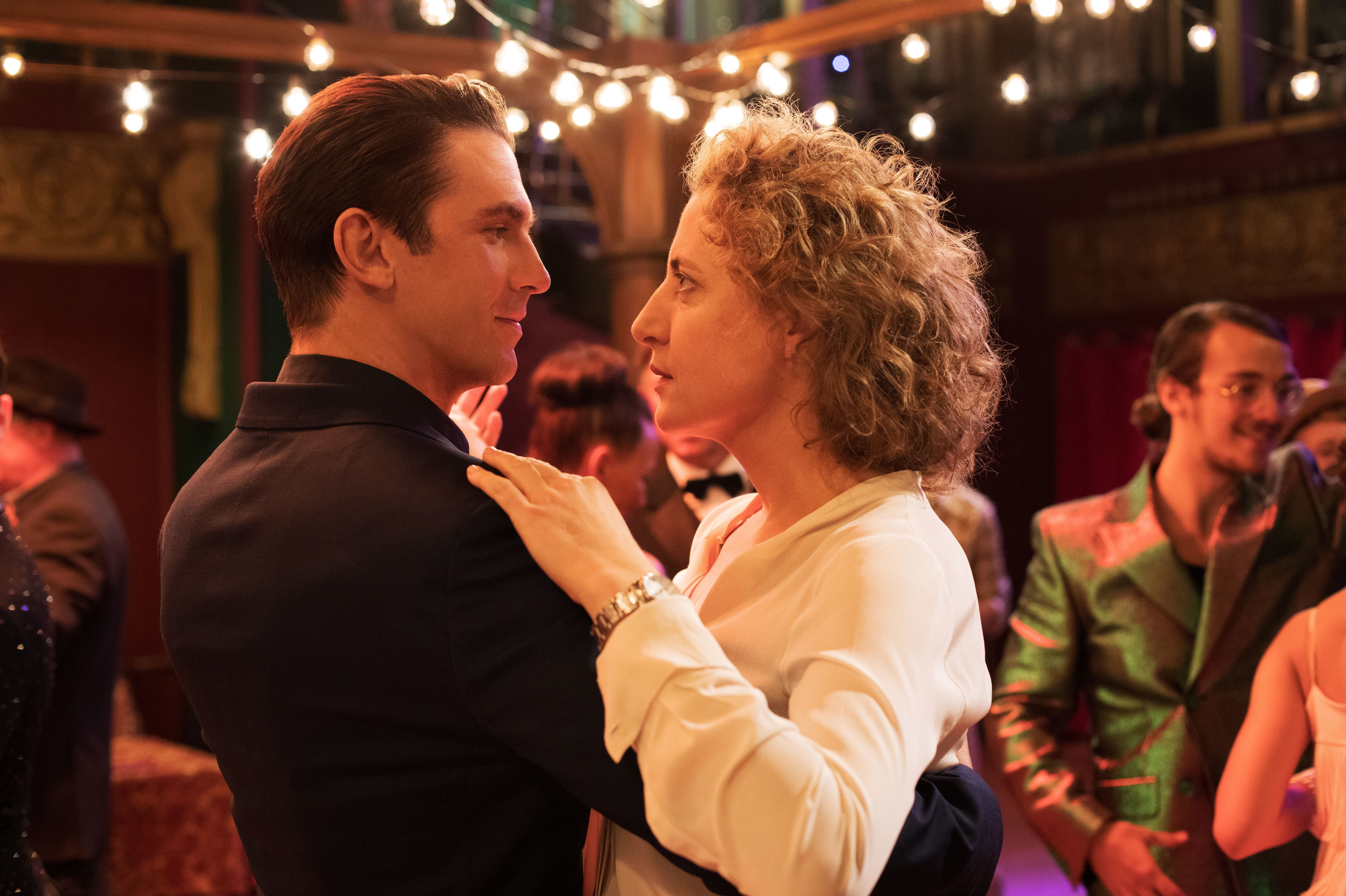 Tom (Dan Stevens) whisks a very skeptical Alma (Maren Eggert) around the dance floor as his precision-tooled algorithm tries to meet her every requirement for the perfect man. (Bleecker Street)