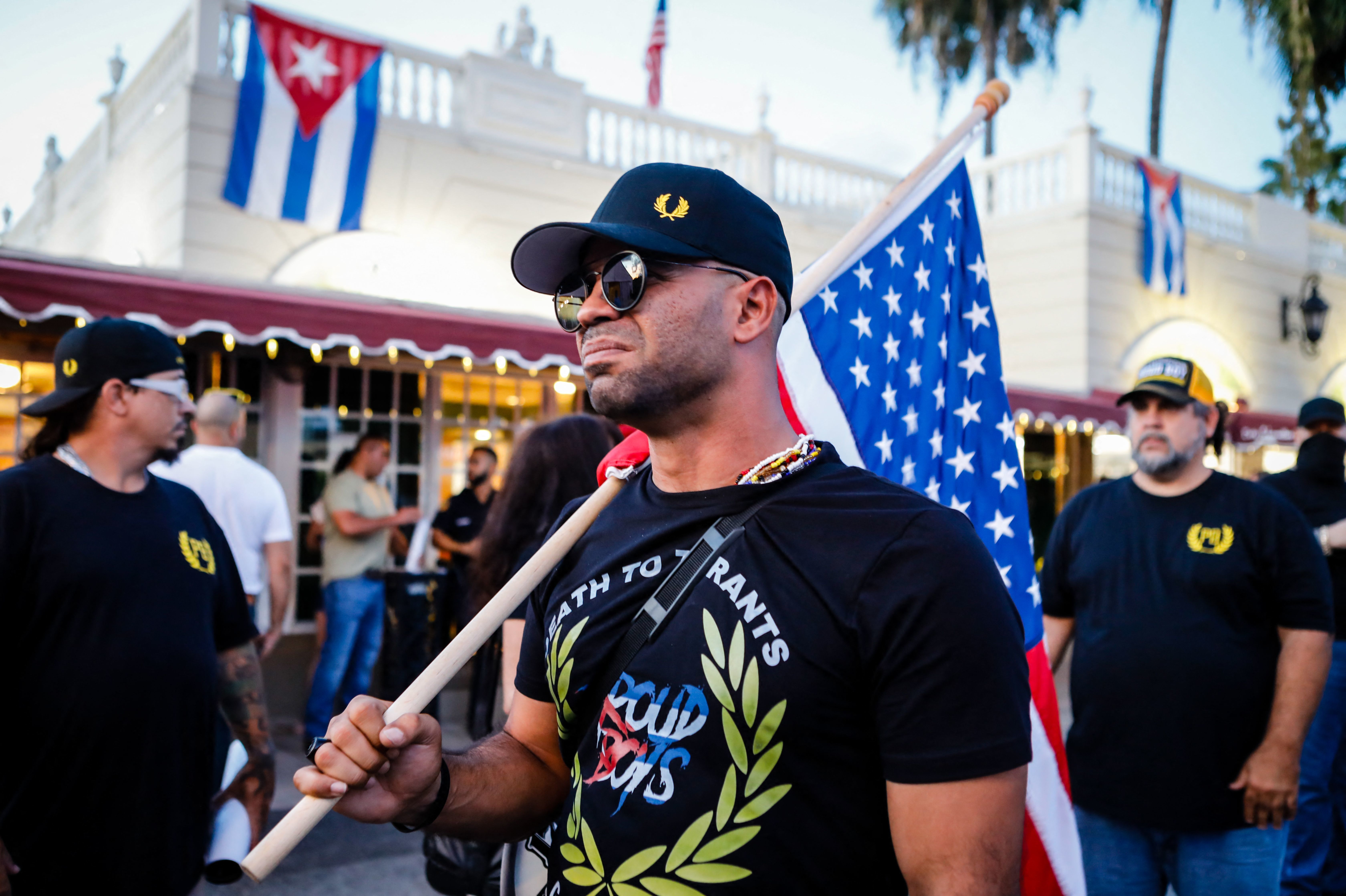 Henry &quot;Enrique&quot; Tarrio, leader of the Proud Boys, holds a U.S. flag during a July protest in Miami as part of a show of solidarity for Cubans who were demonstrating against their government in Cuba. (AFP via Getty Images)