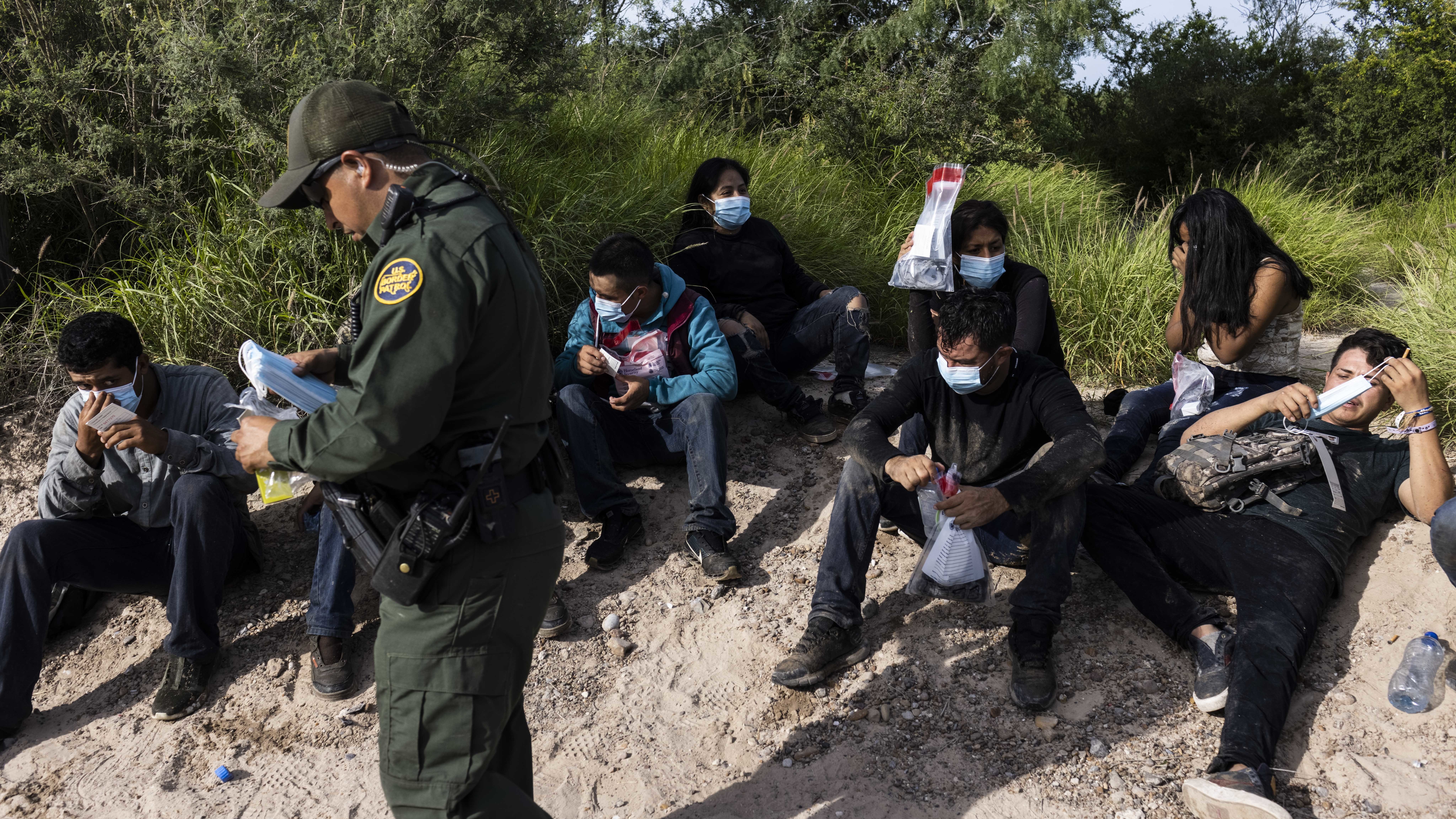 Migrants are apprehended by U.S. Customs and Border Protection agents in LaJoya, Texas, in June. (Bloomberg via Getty Images)