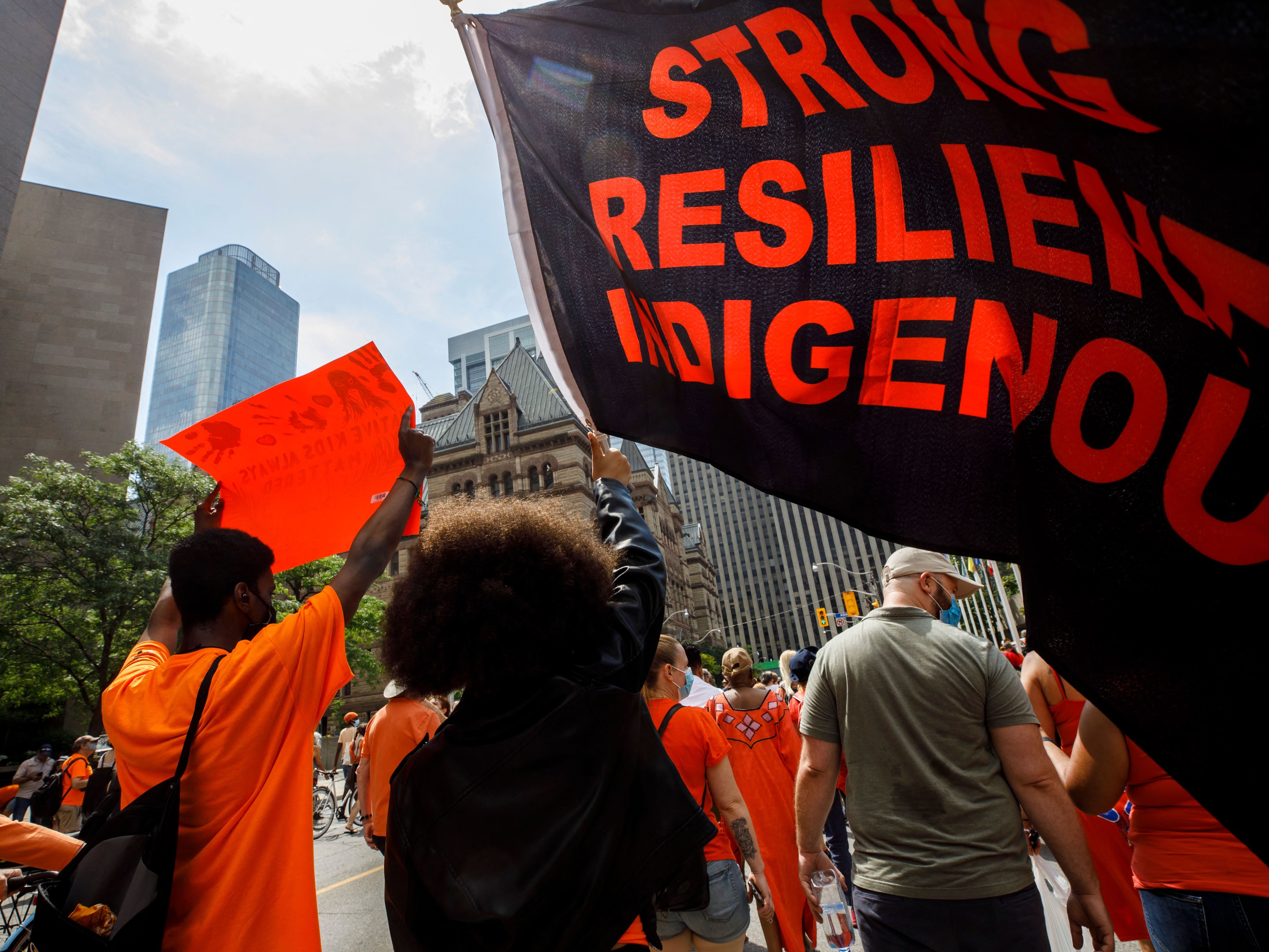 People march during the Every Child Matters walk in honor of children who lost their lives in Canada's Residential School system, in Toronto, Canada, on July 1. (AFP via Getty Images)