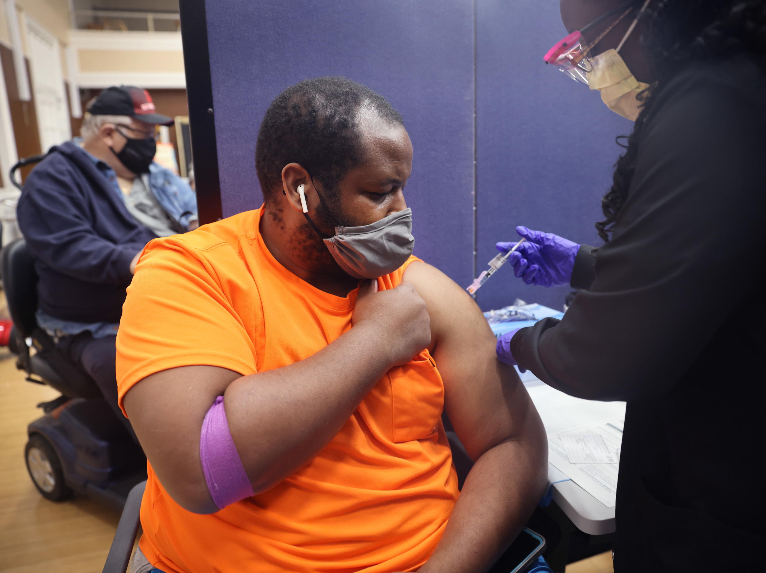 Gloria Clemons gives a COVID-19 vaccine to Navy veteran Perry Johnson at the Edward Hines, Jr. VA Hospital in Hines, Ill., in September. (Getty Images)