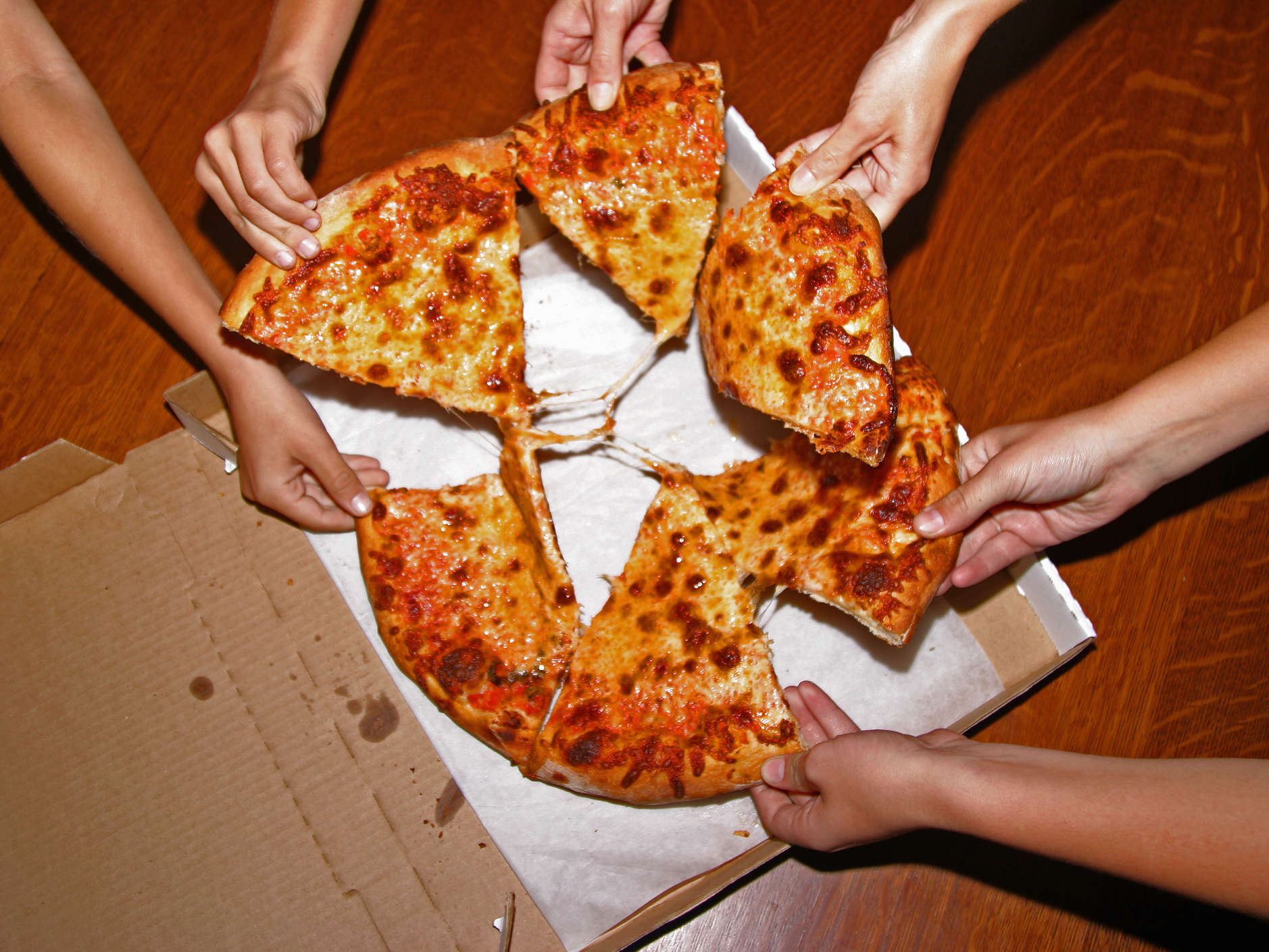 People eating pizzza slices