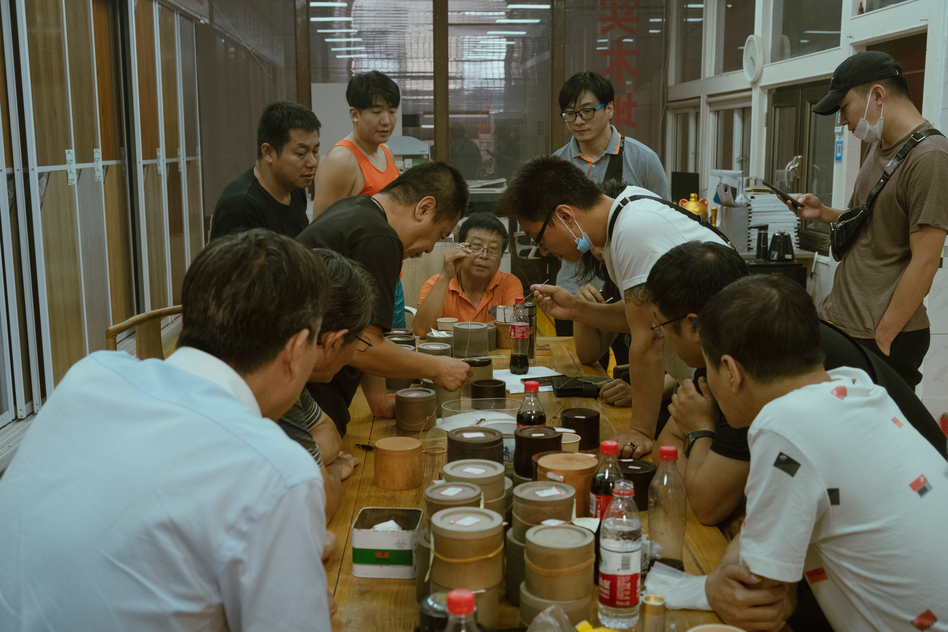Men crowd over a cricket fight in Beijing in September. Competitive cricket fights are believed to have been held for more than 1,000 years in China.